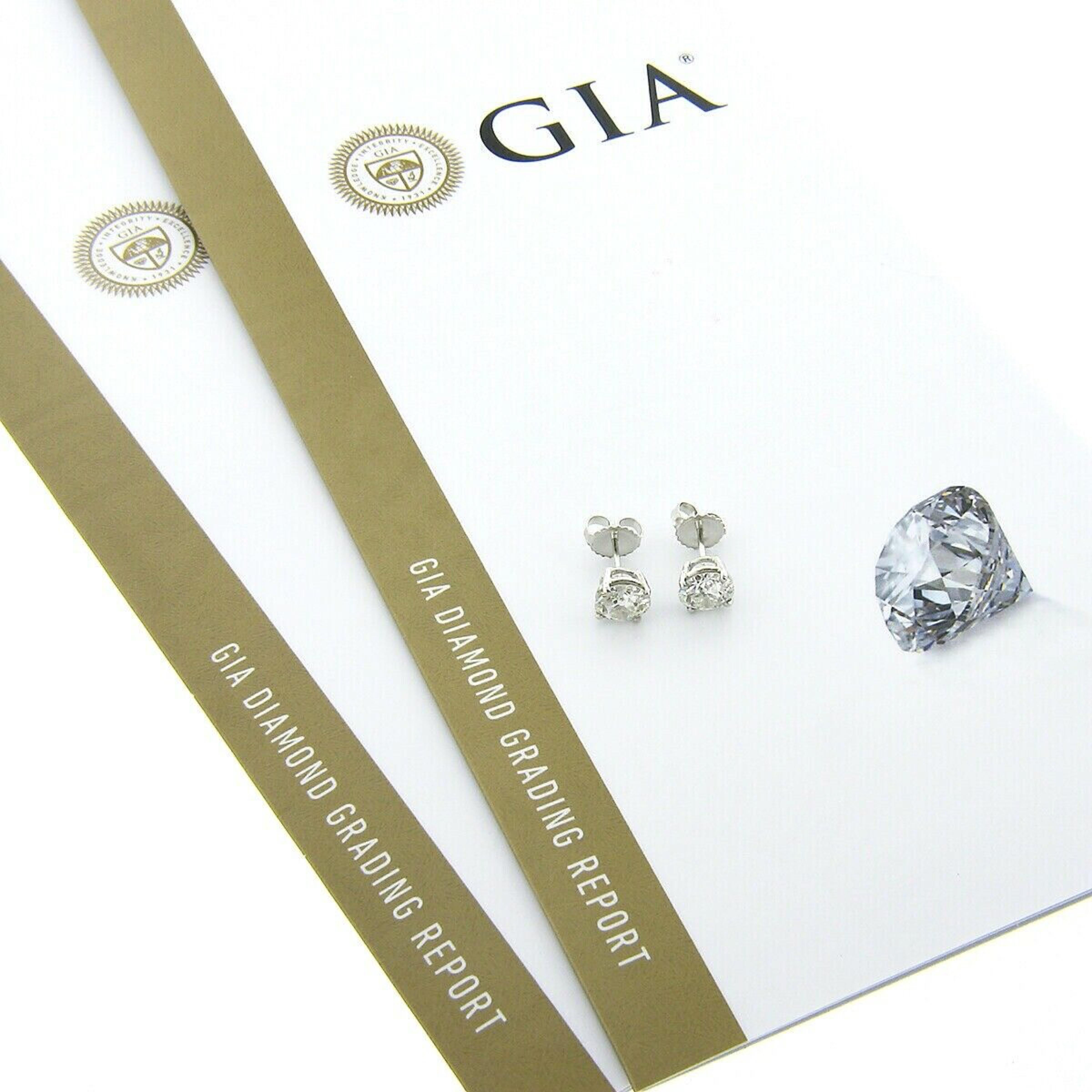 Here we have an outstanding pair of classically styled diamond stud earrings that were newly crafted from solid 950 platinum. They feature a pair of genuine, antique, old European cut diamonds that are each GIA certified and weigh a total of exactly
