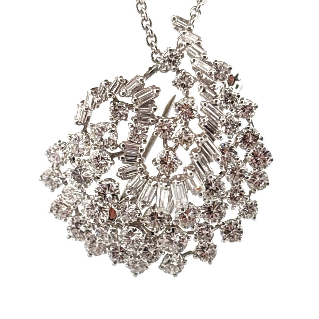 Diese exquisite Anhängerbrosche aus Platin glänzt mit ca. 5,00 Karat Diamanten im Rund- und Baguetteschliff, die meisterhaft in einem dynamischen, floral inspirierten Design angeordnet sind. Eine auffällige Kombination aus runden Brillanten und