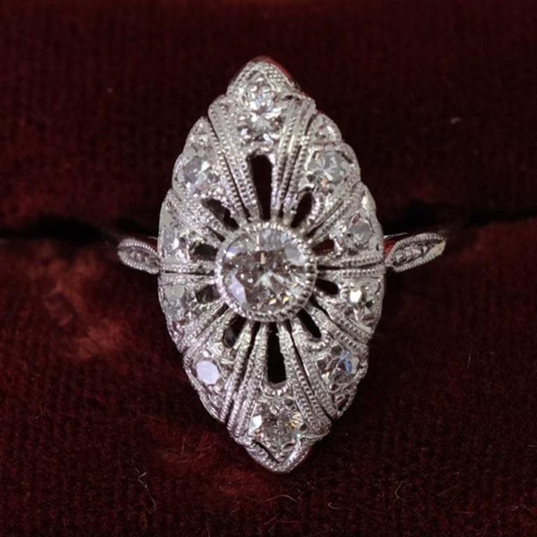 One ladies 14-karat and platinum tested not stamped white gold and diamond antique
filigree style marquise shaped solitaire ring. The center stone is one round old European
cut natural diamond that has a measurement of approximately 4.64 X 4.75 X