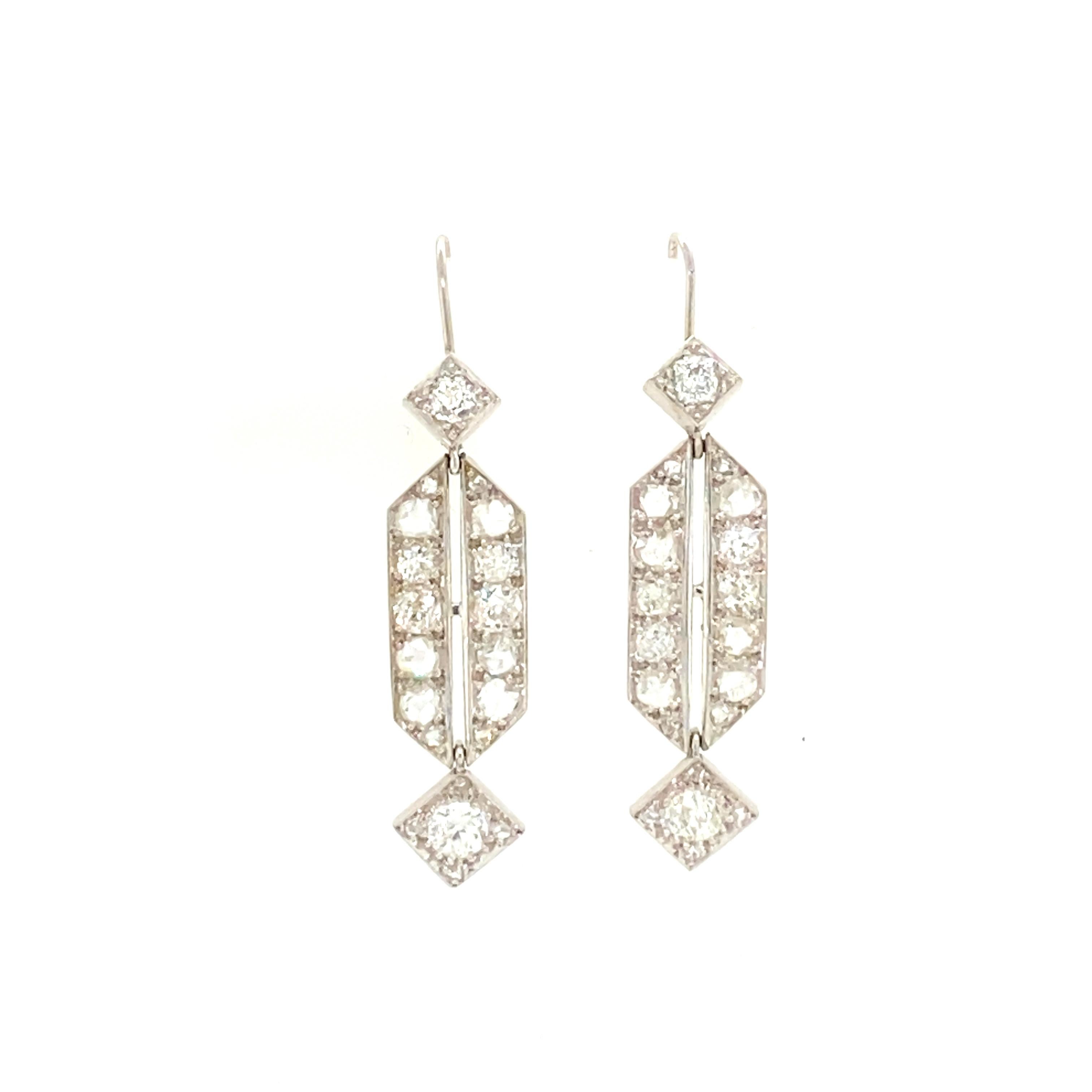 Own a piece of history with these beautiful antique diamond earrings. The dangle hook backs are easy to put in and stay on the ear. The top of the earring is a diamond shape with a round cut diamond center. The center of the earring is long hexagon