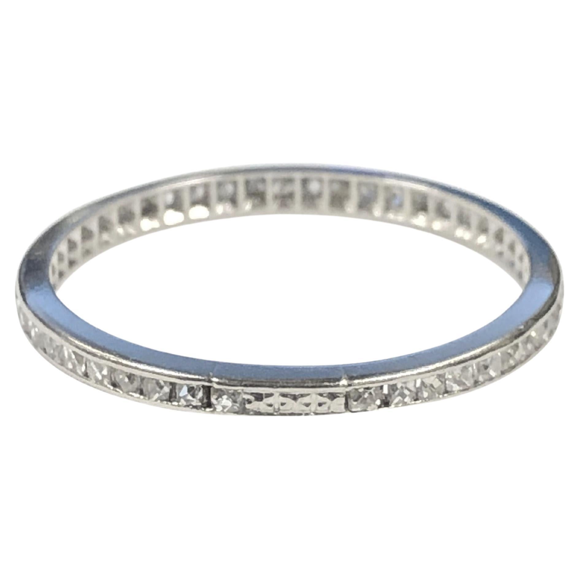 Circa 1920s Platinum Eternity Band Ring, measuring 1.6 M.M. wide, channel set with old French Cut Diamonds totaling approximately .70 Carat. Finger size 6 1/4. 