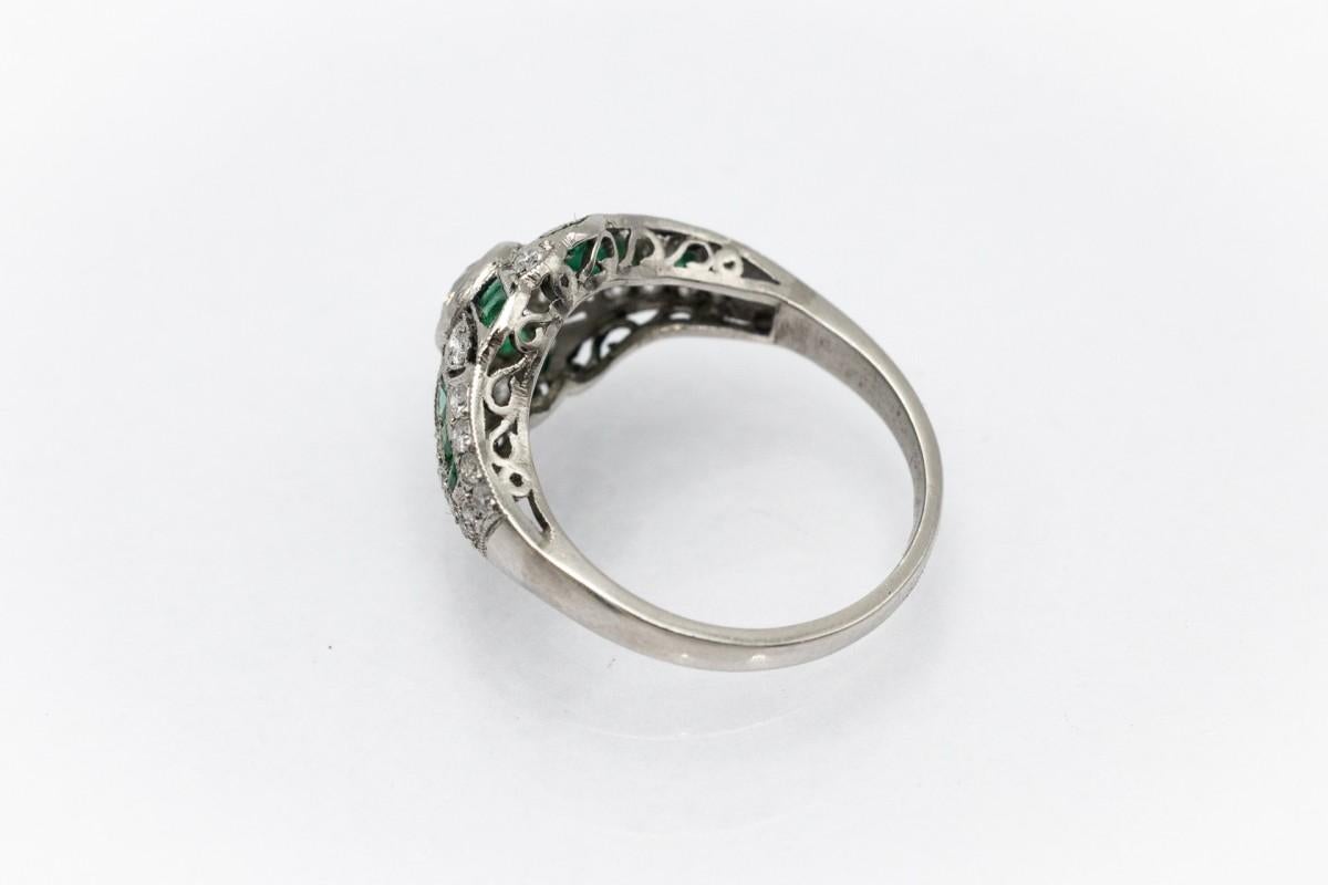 Old European Cut Antique Platinum Art Deco ring with emeralds and diamonds, circa 1930s.