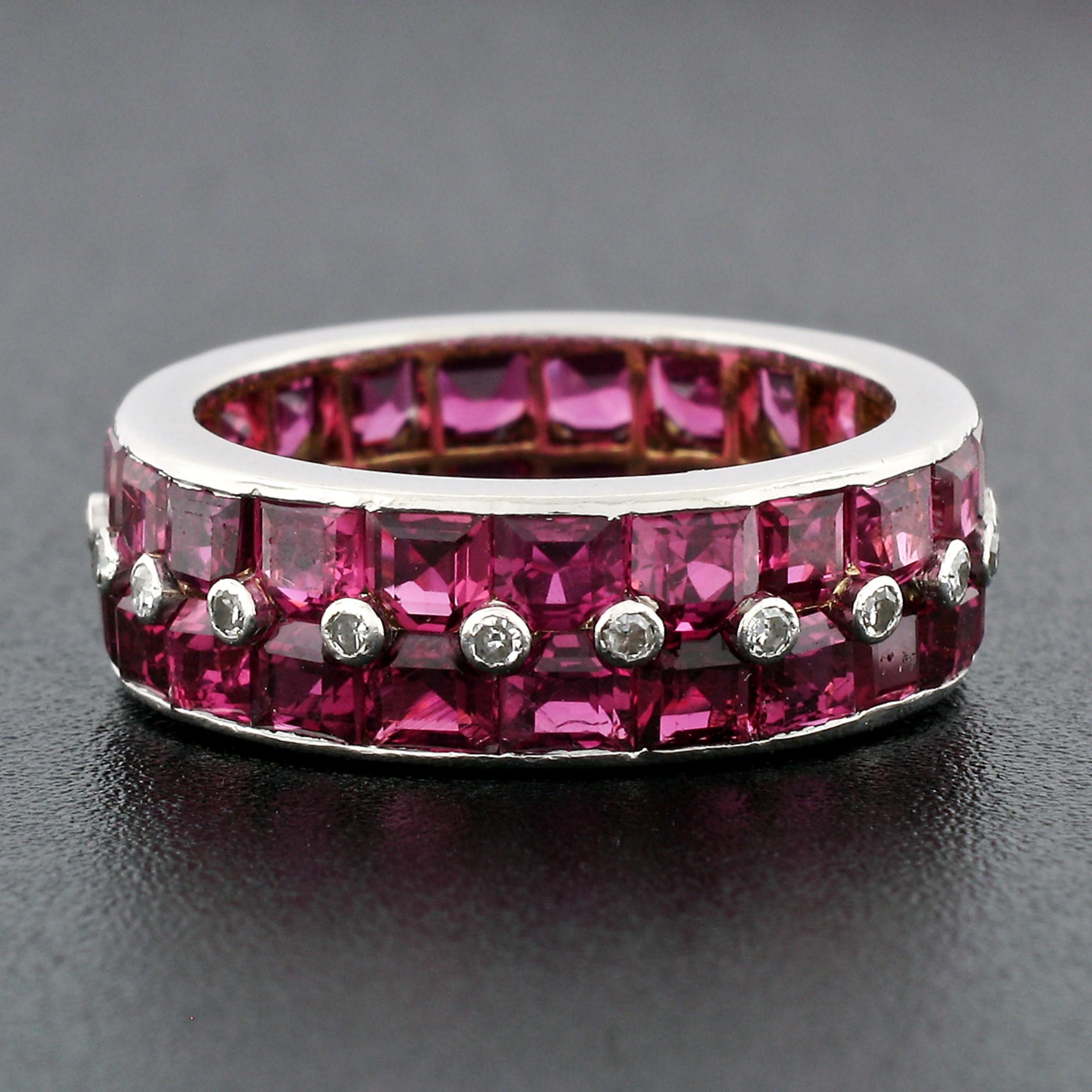 Here we have an absolutely breathtaking antique ruby and diamond wide eternity band ring, crafted from solid platinum and 18k yellow gold. The band features two rows of square step cut channel set rubies, adorned by bezel set diamonds throughout.