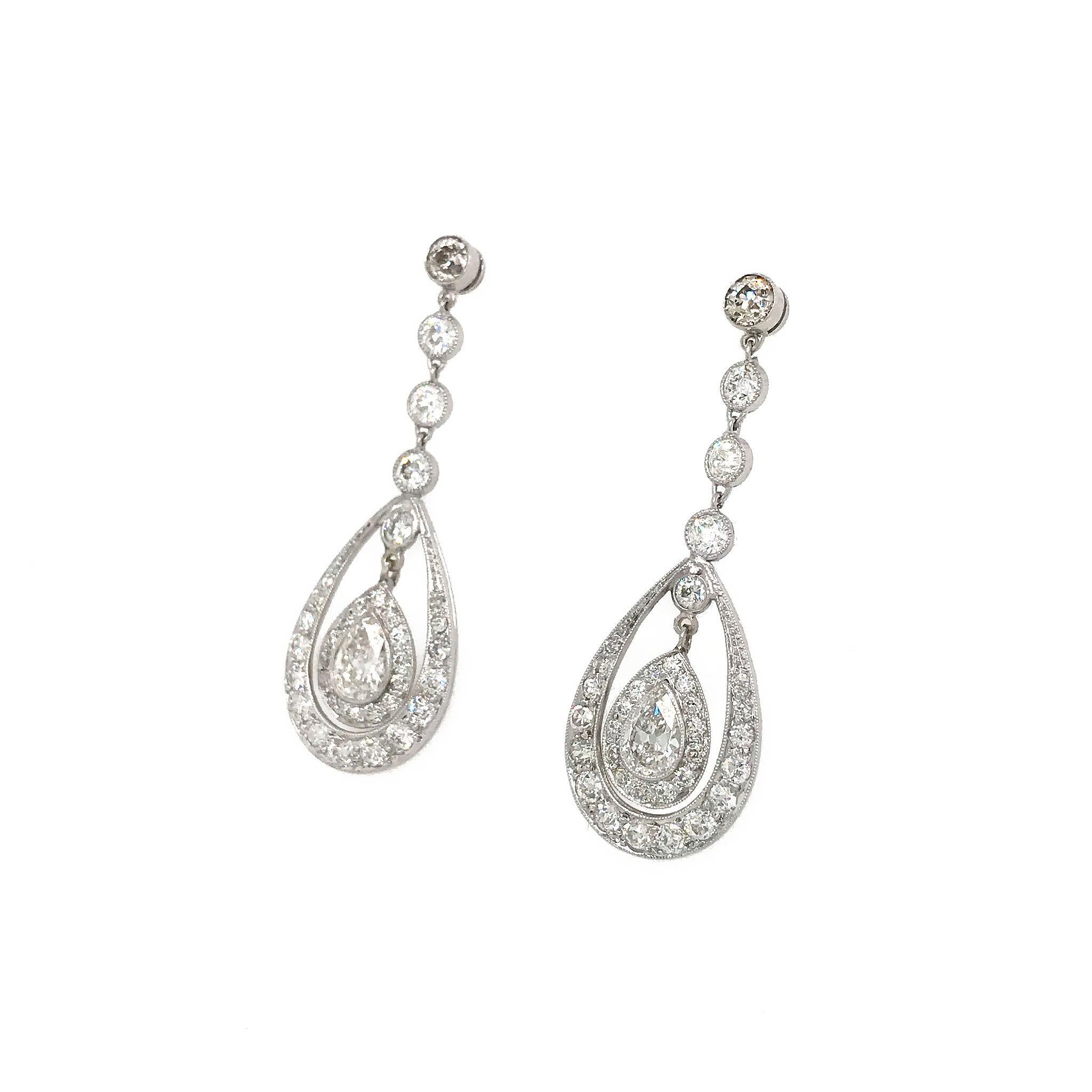 The movement and style of these earrings show off their charm and beauty.
Platinum
Diamond: 3.0ct twd (estimated)
Center Pear shapes (est) wt. .50 carats each
Earrings Length: 1.60 inches
Total Weight: 6.2 grams
F- Color VS-Clarity
