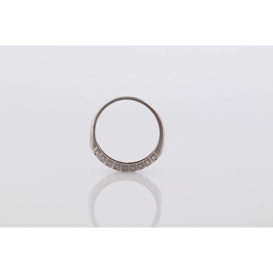 Vintage from the 1950s
Materials: Stone
Gemstone: Diamond
Gem color: Colorless
Band color: Silver
Style: Art deco
Beautiful Platinum band 9 diamonds channel set.

Details:
3mm wide band
9 diamonds total est. 0.21ctw
2.2grams total
10% iridium 90%