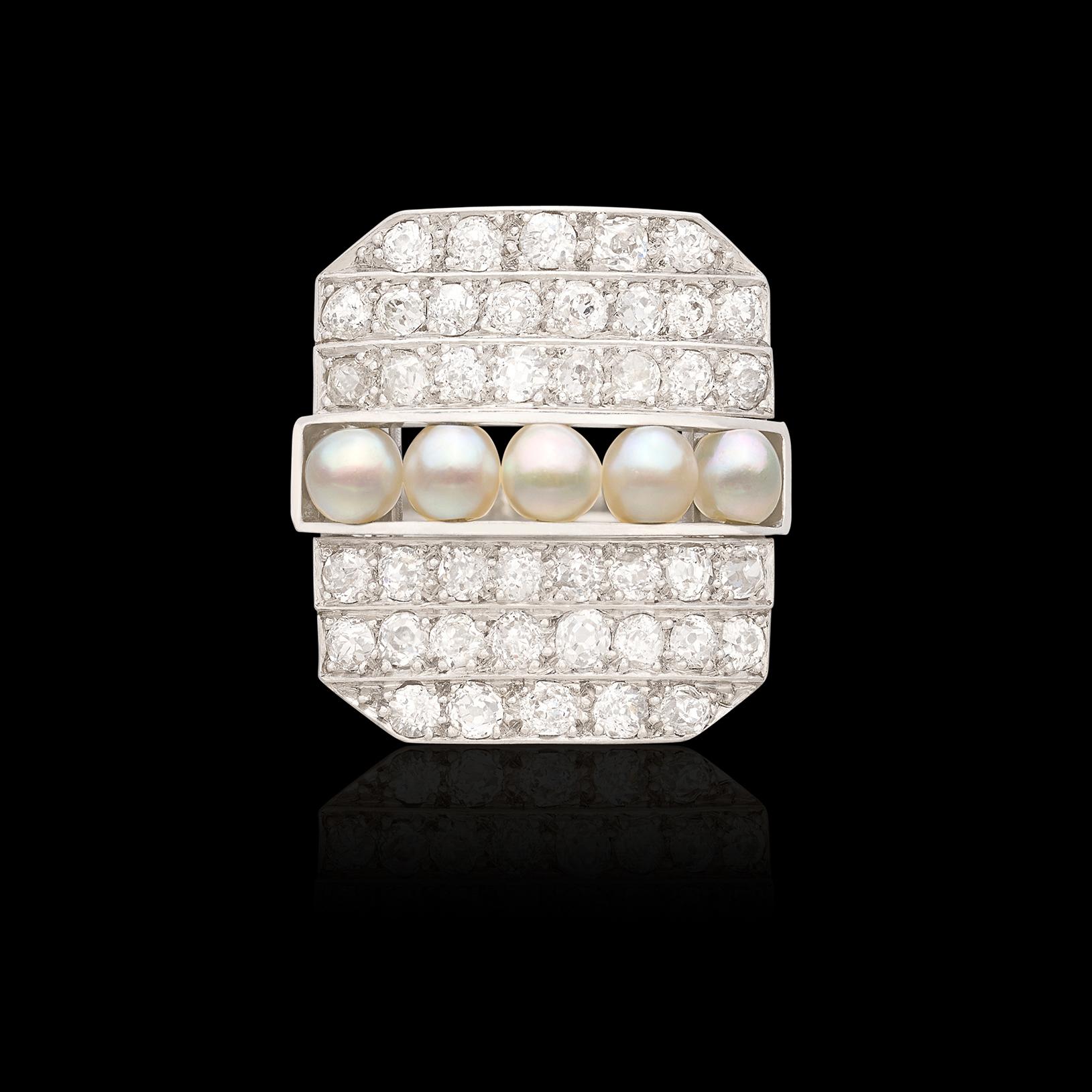 Own a gorgeous piece of history! This antique platinum ring features 42 exceptional Old European Cut diamonds perfectly set in the face of the ring with 5 perfectly matched pearls set in the middle of the ring. The antique cocktail ring circa late