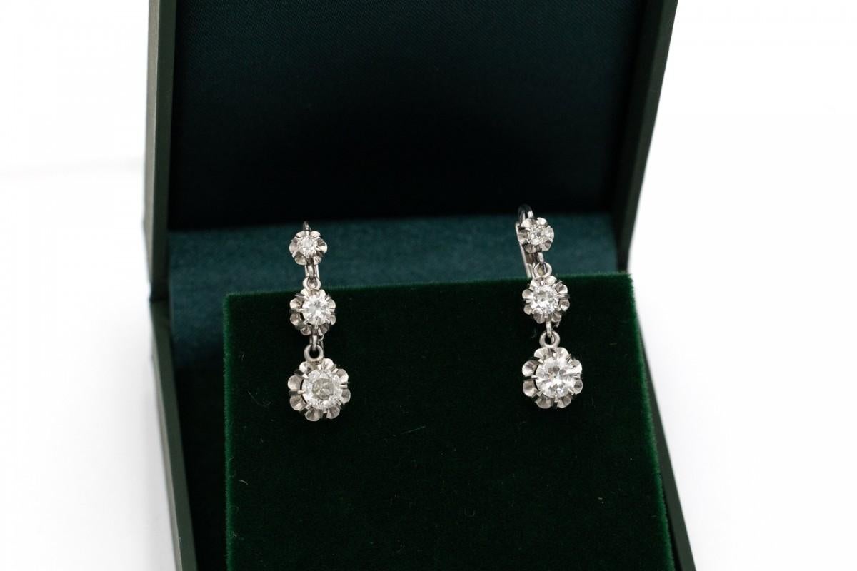 Antique earrings studded with old brilliant-cut diamonds. Made of 18 carat white gold, which ensures durability, and 0.900 platinum. Platinum perfectly displays noble stones, emphasizing their unique shine and purity.

The English clasp ensures