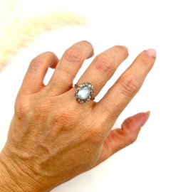 Antique Platinum, Edwardian era Cabochon Moonstone and Rose Cut Diamond Ring