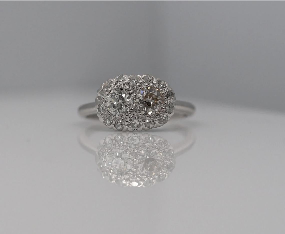 Item Description:

Here we have an amazing engagement ring, which is very unique. It has two center stones which are approximately .35cts each. It is then surrounded by a halo of diamonds as well. The diamonds are all old cut, and the piece sparkles