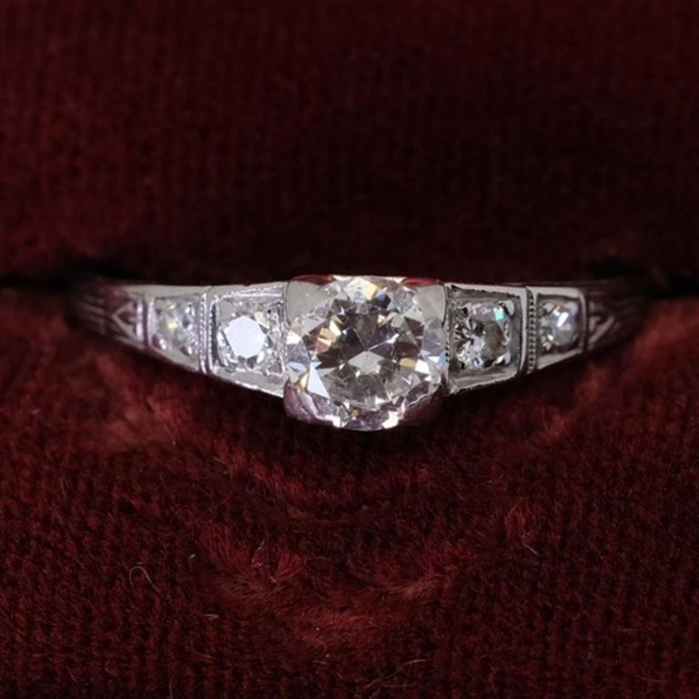One ladies platinum and diamond engagement ring. The center stone set is one old
European cut diamond that measures 5.23 X 5.28 X 3.00 mm and weighs 0.53 carats.
The clarity grade is VS2 and color grade is H. The ring is also set with four single