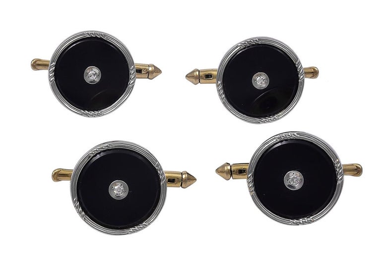 A complete men's dress set:  two double-sided cufflinks, four vest buttons and three studs.  Onyx with bezel-set diamond centers.  The onyx and diamonds are set in platinum.  The backings and connectors are 14K gold.   This is the classic set, good