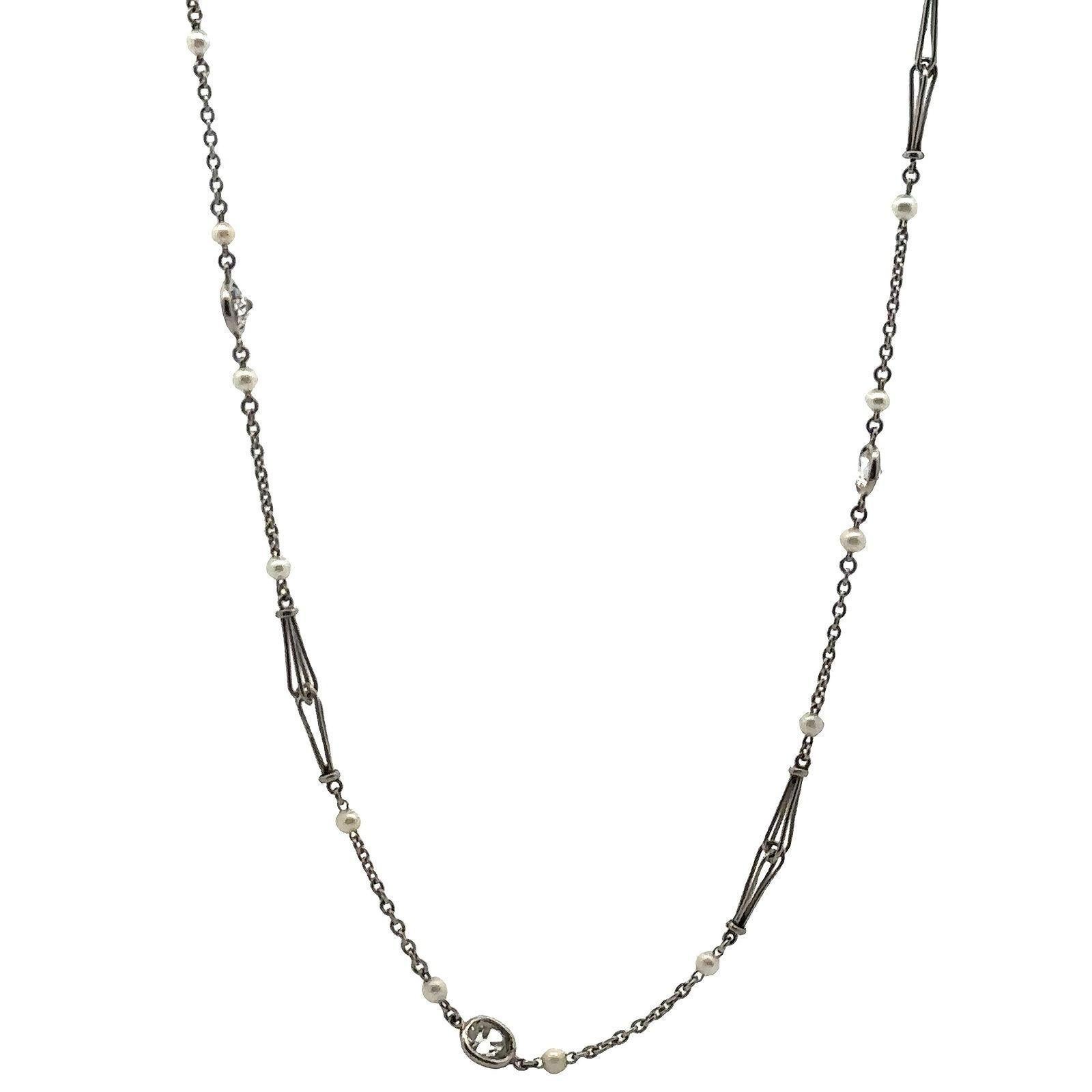This elegant antique long chain is beautifully crafted in platinum and features a sophisticated integration of micro natural pearls and 10 natural old mine cut diamonds, together weighing approximately 1.75 carats (H–K color, SI clarity). The