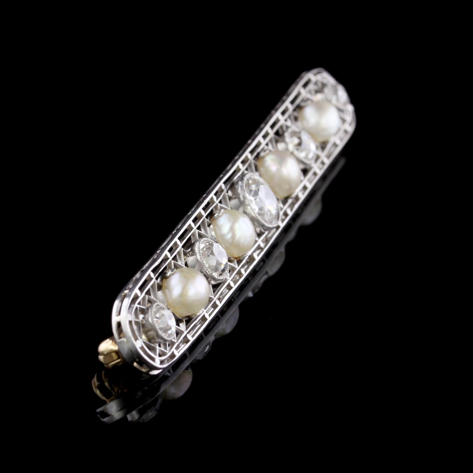 Antique Platinum Natural Pearl and Diamond Pin. The pin is set with 5 old mine cut diamonds weighing approx. 1.91cttw., I-J color, VS-SI clarity, further set with 4 natural pearls ranging in size from 5.34 to 5.80mm., GIA report #2175643818, stating