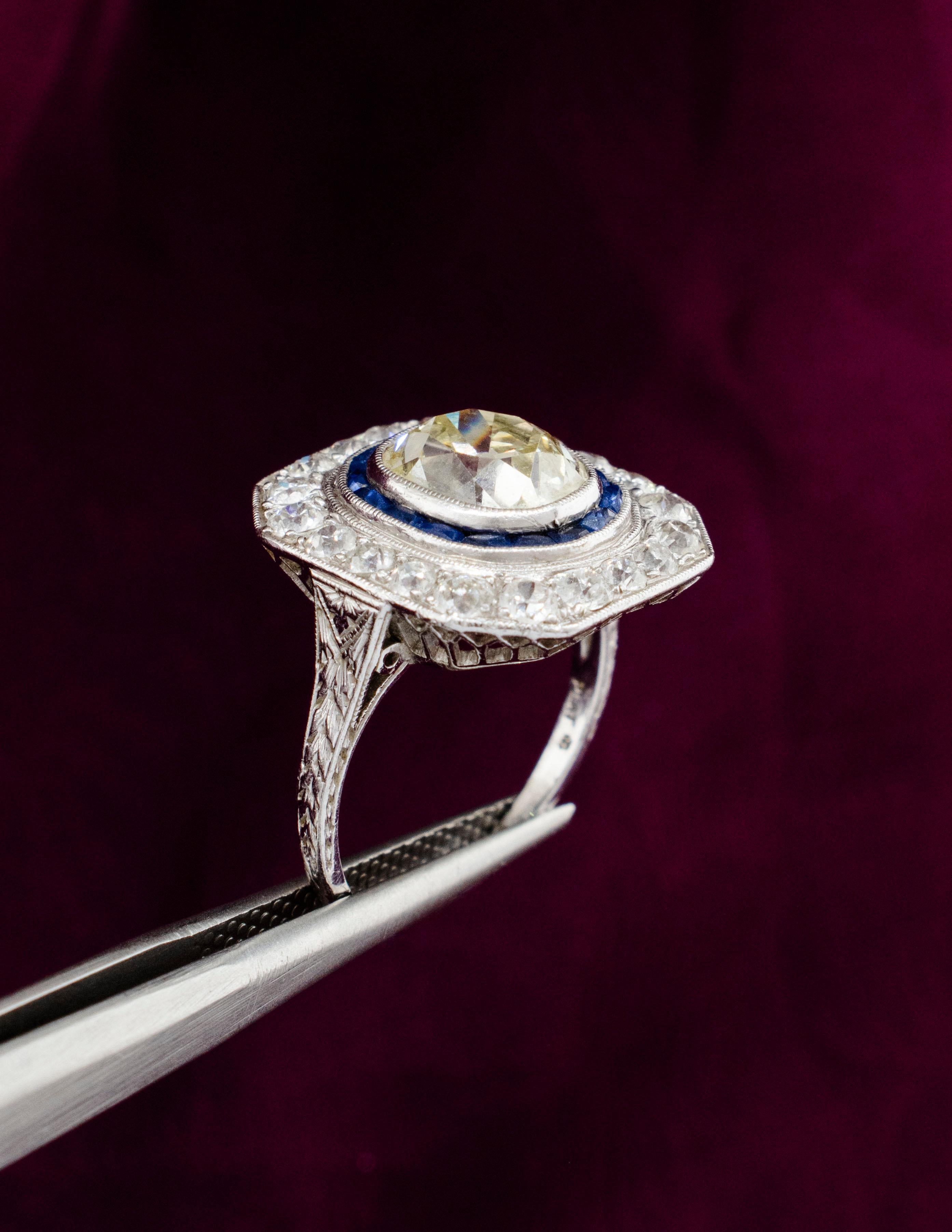 An Exquisite Art Deco Antique Platinum Ring in all original condition. The European Cushion cut center Diamond is a perfect example of the 1920's art of diamond cutting. The center stone weighs approximately 3.22 carats, grading SI1 clarity and