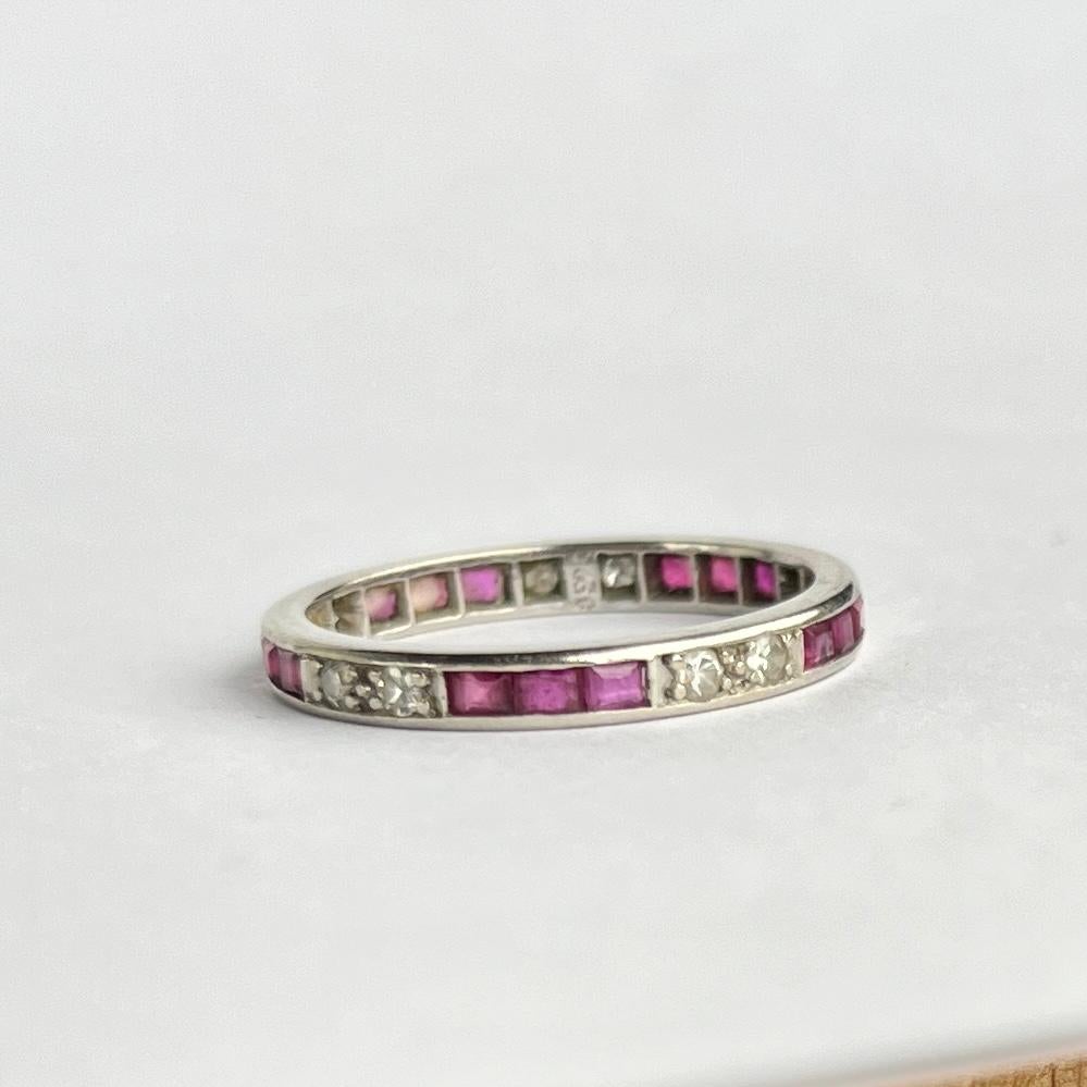 This eternity band holds trios of rubies and pairs of diamonds in-between. The eternity band is modelled in platinum. The ruby total is 45pts and the diamond total is 30pts. 

Ring Size: N or 6 3/4 
Band Width: 2mm

Weight: 2.7