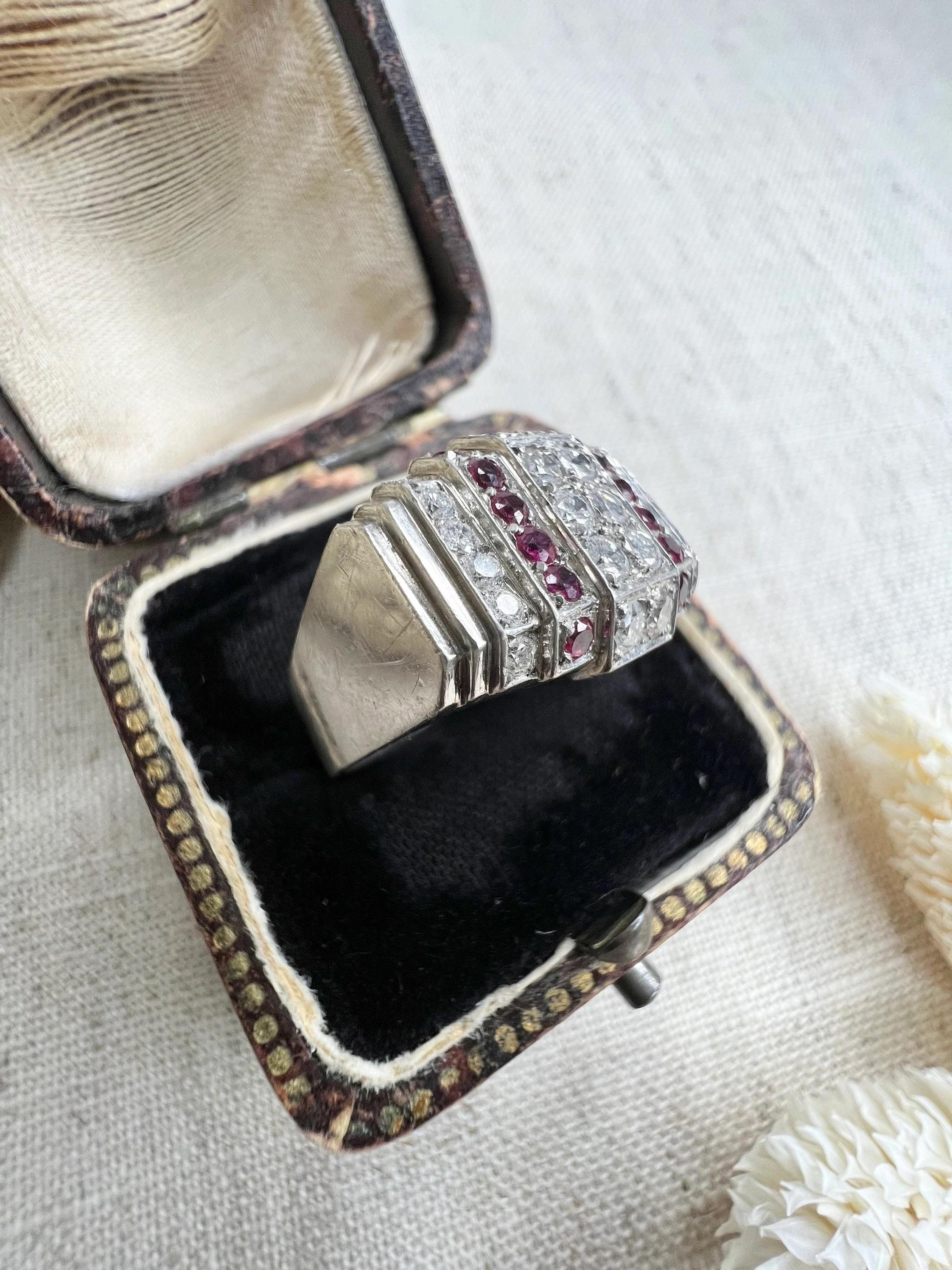 Antique Tank Ring 

Platinum

Circa 1920’s

Fabulous Art Deco Design Plaque/Tank Ring. Set with Rubies & Diamonds in a Beautiful Geometric Setting. 

Ring Measures Approx Height 11.7mm & Width 17.2mm

UK Size L 

US Size 6

Can be resized using our