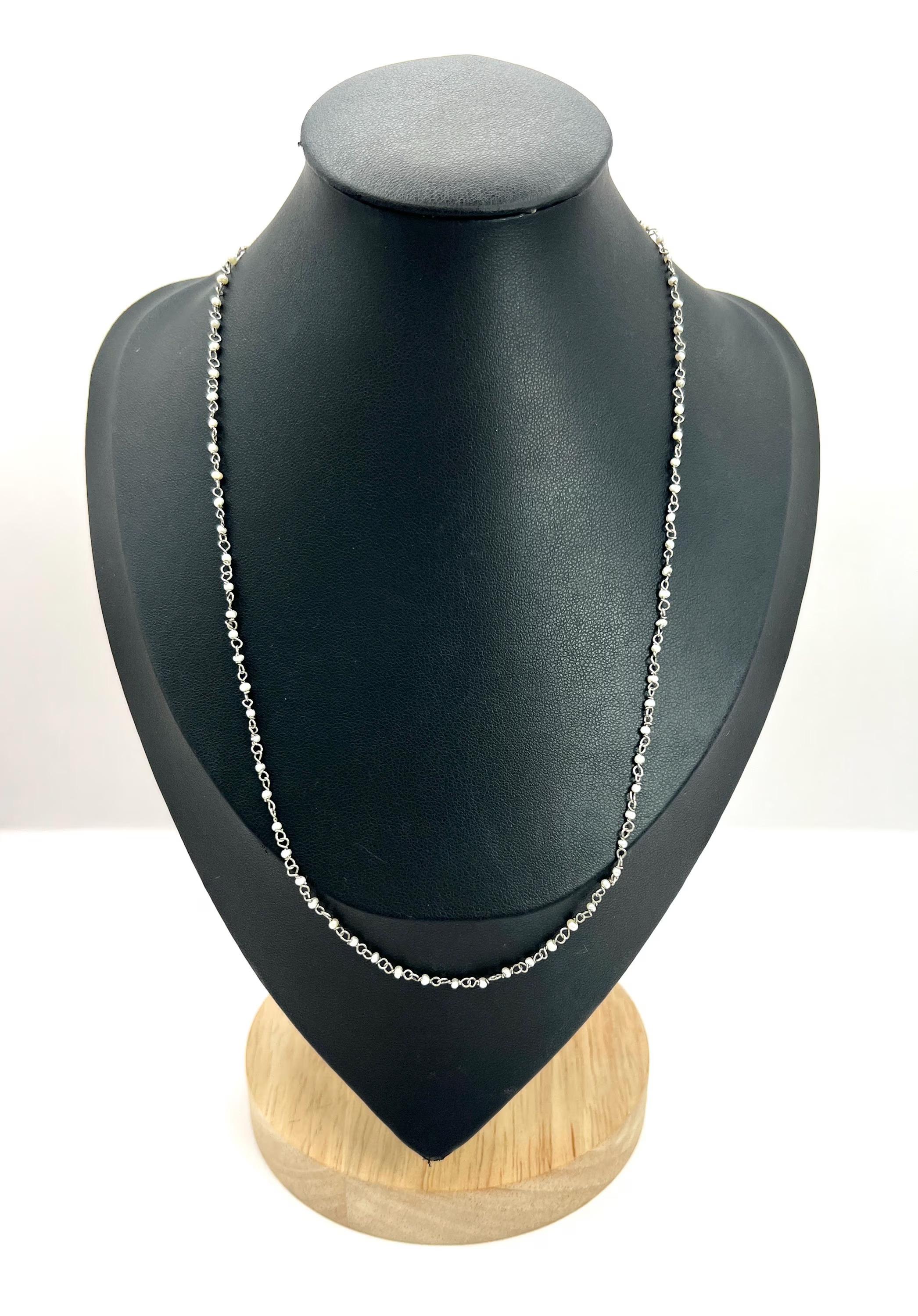 Edwardian Pearl Necklace

Platinum Stamped 950 

Circa 1910

This exquisite Edwardian-era platinum necklace is a timeless piece that beautifully captures the elegance of its time. Featuring a beaded chain of platinum links and seed pearls, creating