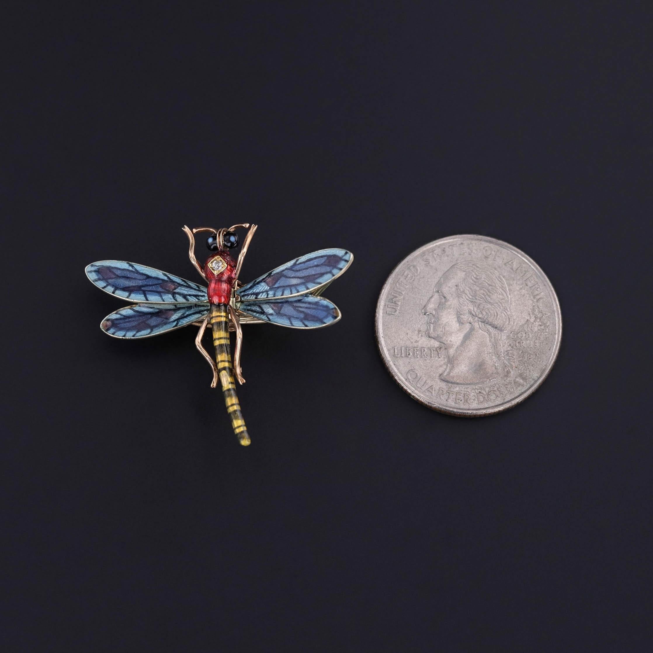 A 14k gold dragonfly scarf clip from 1908, featuring wings of blue plique a jour enamel and a diamond accent. The wings fold to open the clip on the back allowing the piece to be worn as a brooch, scarf clip, or on a chain.

The piece measures 1.1