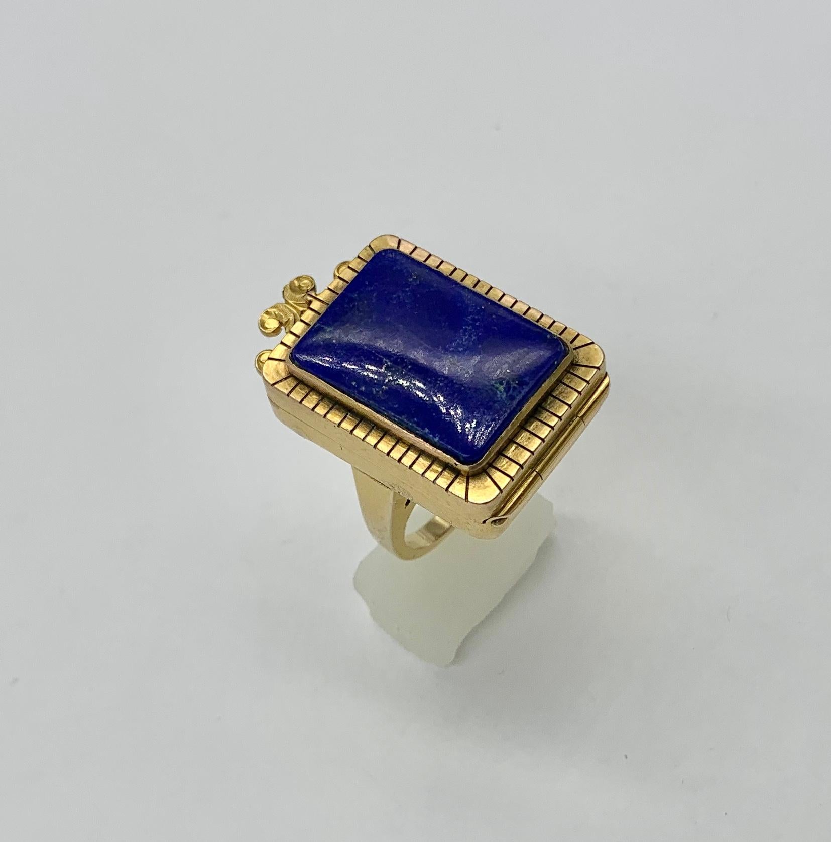 The magnificent locket or poison ring is an antique gem.  It features an absolutely gorgeous rectangular Lapis Lazuli gem in the center of the 14 Karat Gold Ring.  The top of the ring opens to reveal a locket compartment.   Antique rings such as