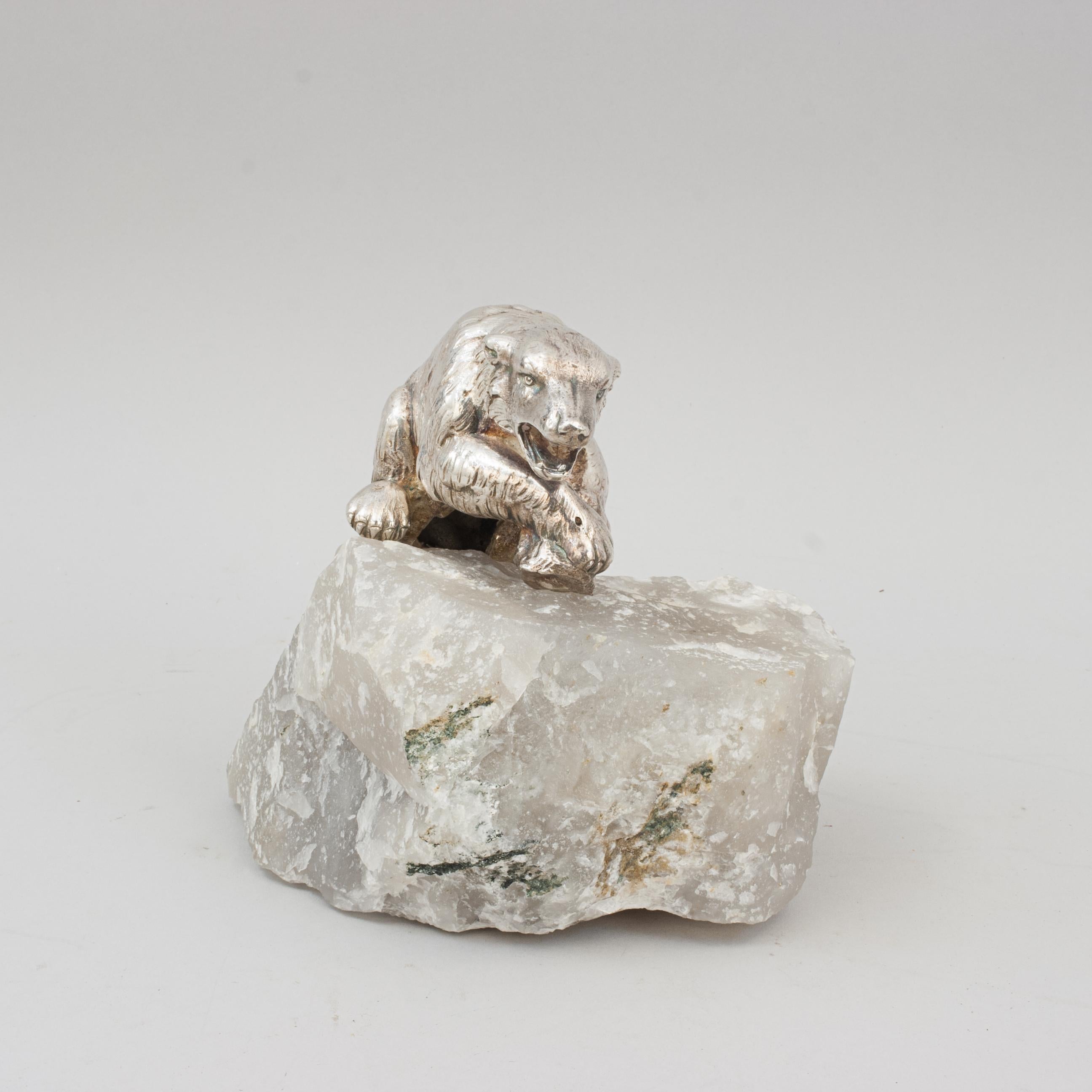 Vintage Polar Bear Sculpture.
An arctic sculpture of a polar bear on an iceberg. The polar bear is well made, silver plated and the iceberg is made of quartz. The study of the polar bear is modelled climbing onto the ice, ears back and mouth