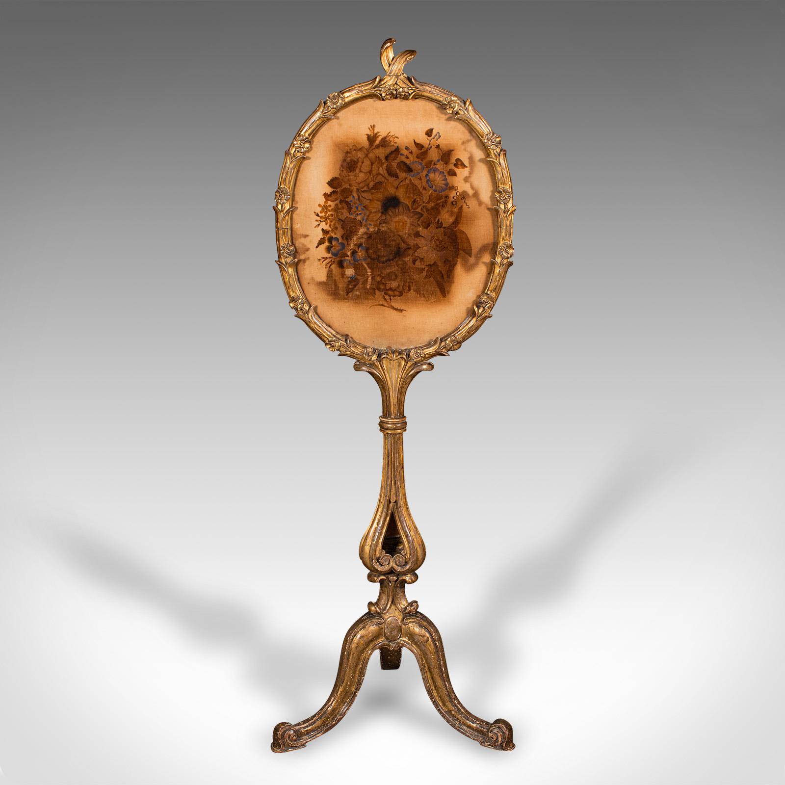 
This is an antique pole screen. An English, giltwood and glass fireside reflector, dating to the Regency period, circa 1820.

Fine Regency craftsmanship with a Dutch influence to the decor
Displays a desirable aged patina and in good order - small