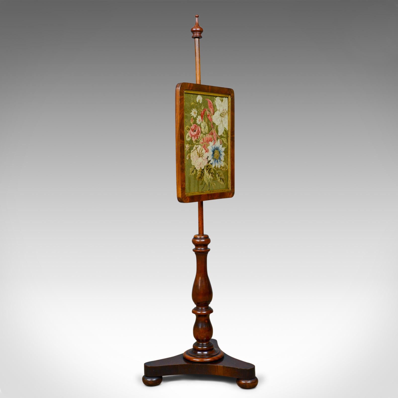 This is an antique pole screen. An English, Regency, walnut fire screen with needlepoint tapestry panel dating to the early 19th century, circa 1820.

The adjustable screen panel is easy to position
Secured in place by a brass thumb screw

An