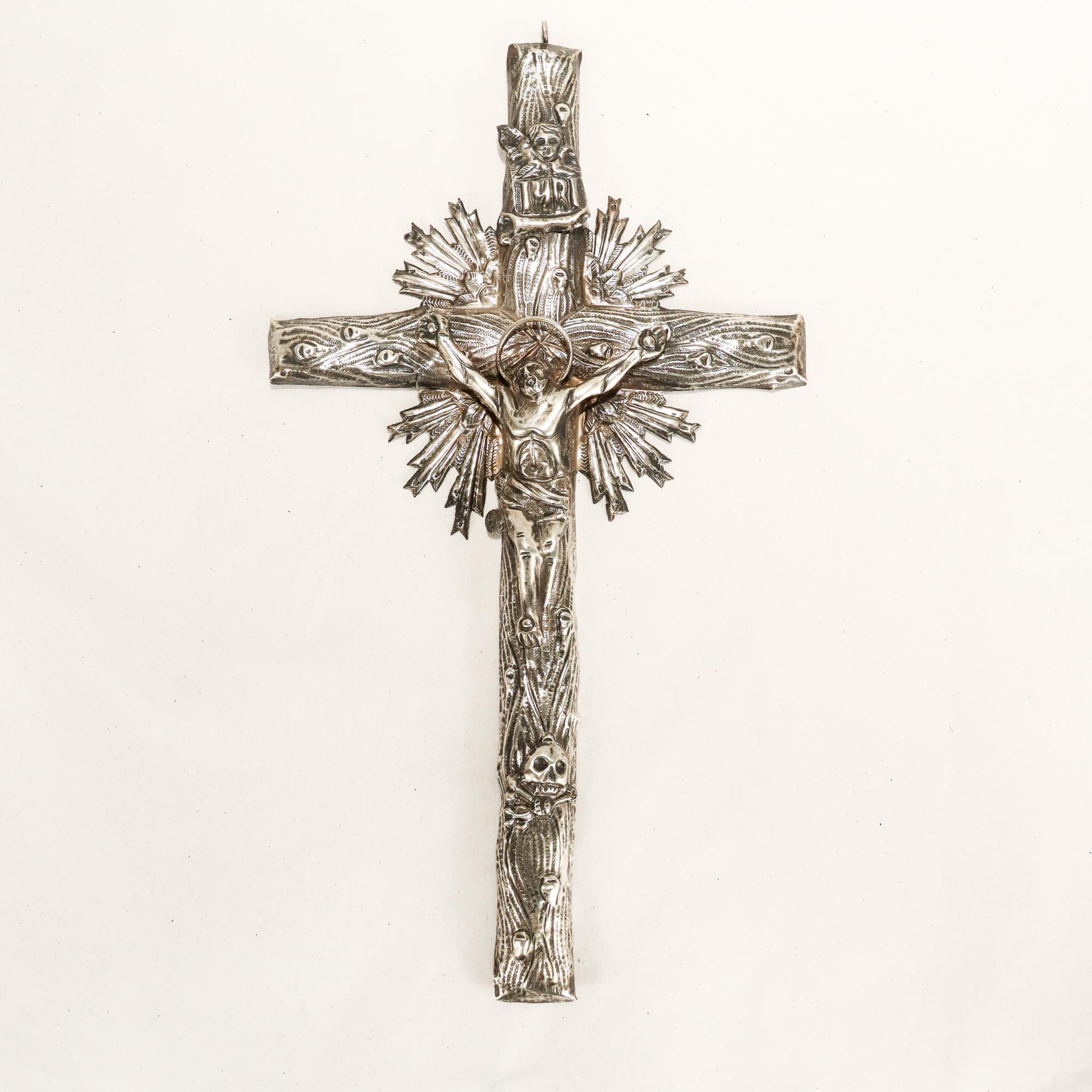 A fine antique Eastern orthodox silver crucifix.

In (what we believe to be) .800 polish silver.

The crucifix with a wood grain in front of a stylized star and mounted with an INRI plaque, a Christ figure, and a skull & crossbones.

Mounted to the
