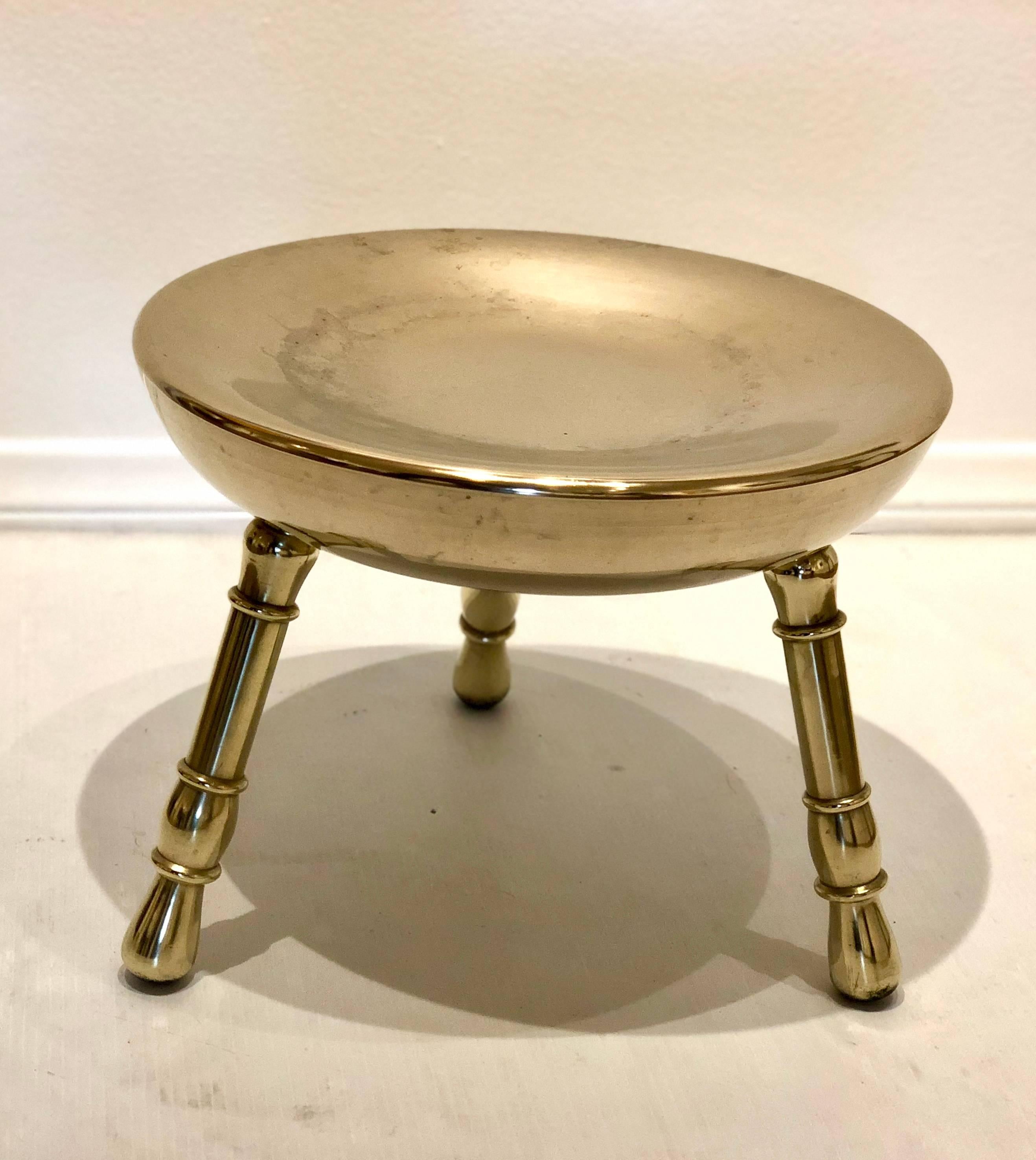 Solid polished brass low stool circa 1950s, incredible solid and sturdy the legs unscrew and have thread that goes into the seat, we polished the stool and will patina with age.