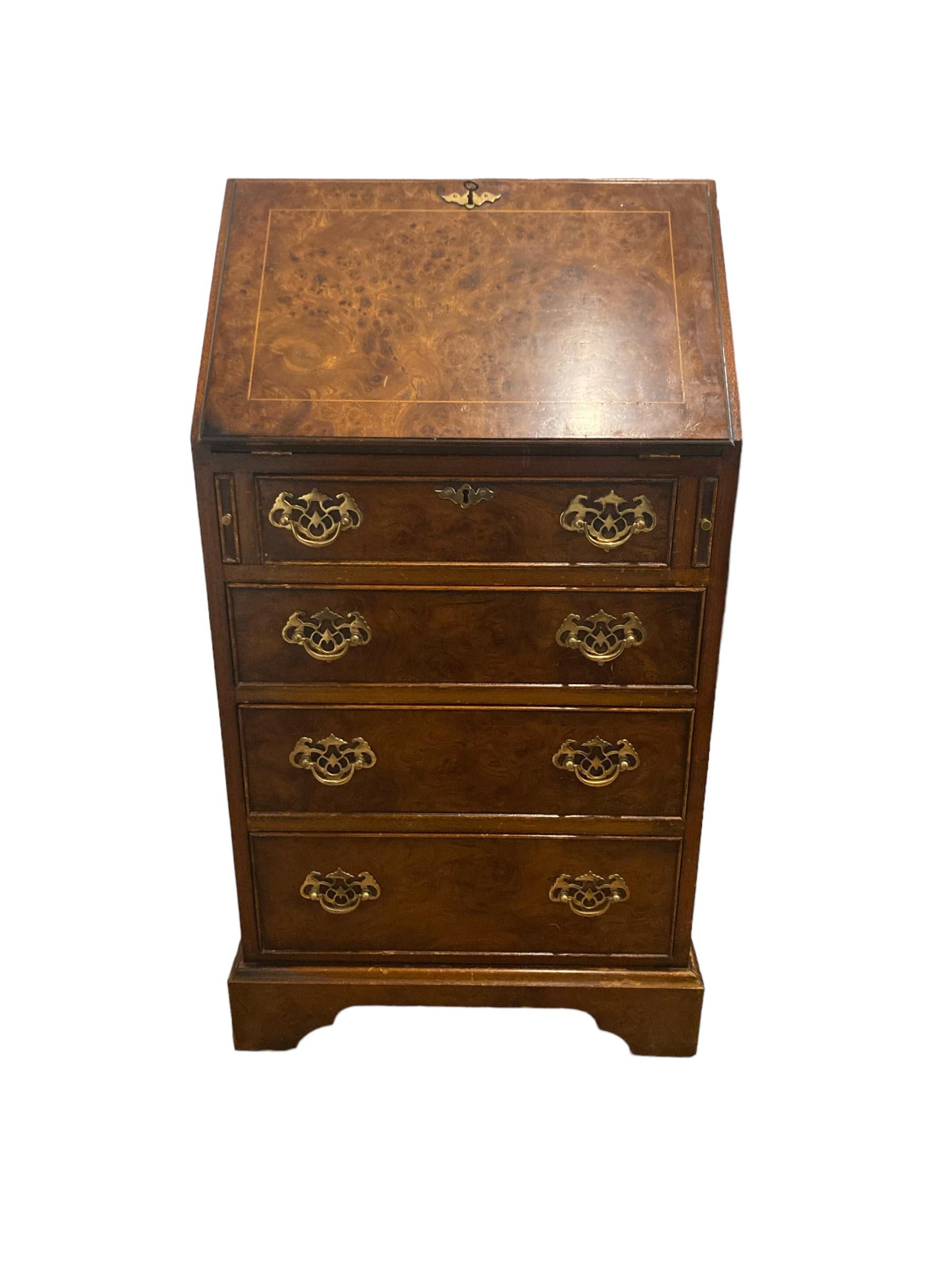 This exquisite wooden bureau, a perfect addition to any home or office space. Crafted with precision, this bureau features a sleek design with four spacious drawers, providing ample storage for your essentials. The brass handle adds a touch of