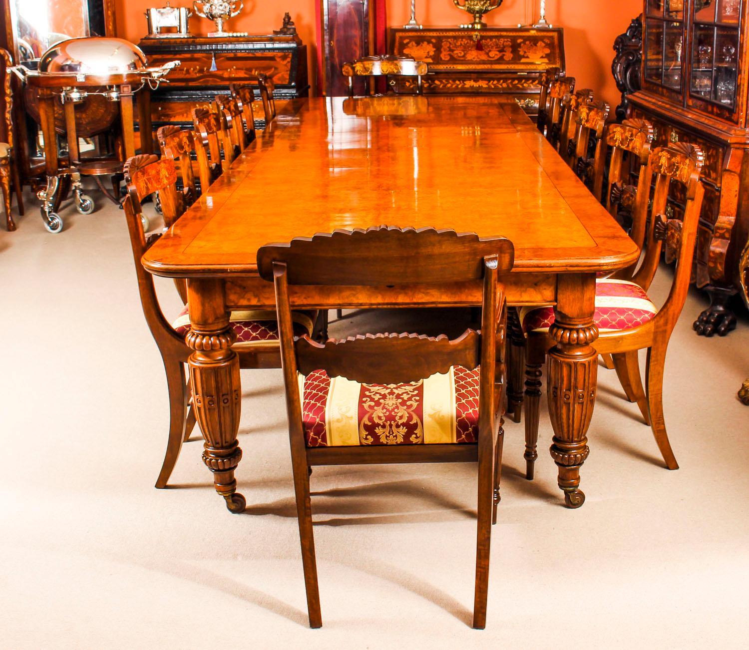 There is no mistaking the style and sophisticated design of this exquisite dining set comprising a rare English antique Victorian pollard oak extending dining table, circa 1860 in date and a set of twelve contemporary inlaid dining chairs. 
The