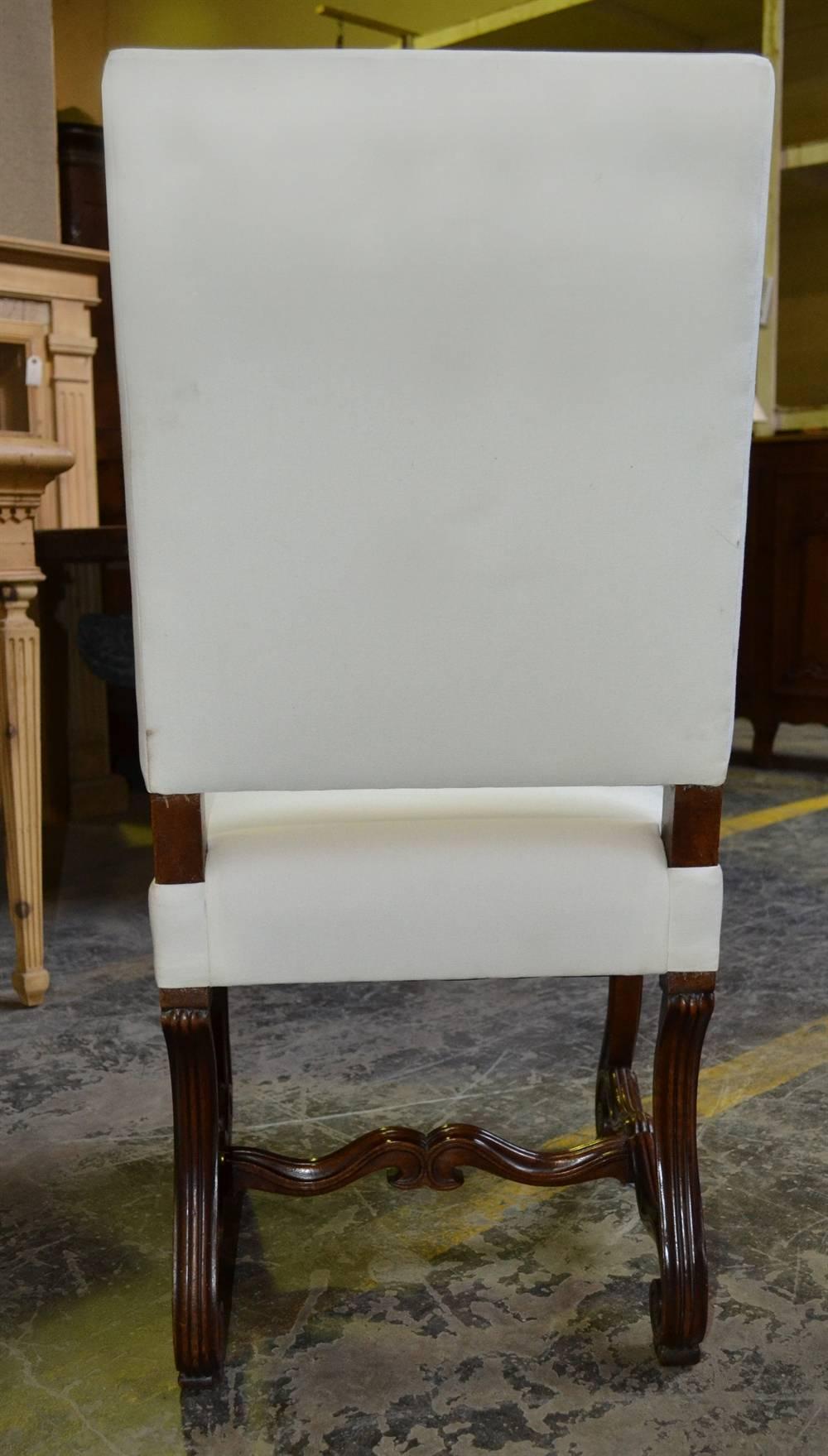 This stately chair is an antique piece of wonderful quality. It is enhanced by its elaborate base and its imposing height.