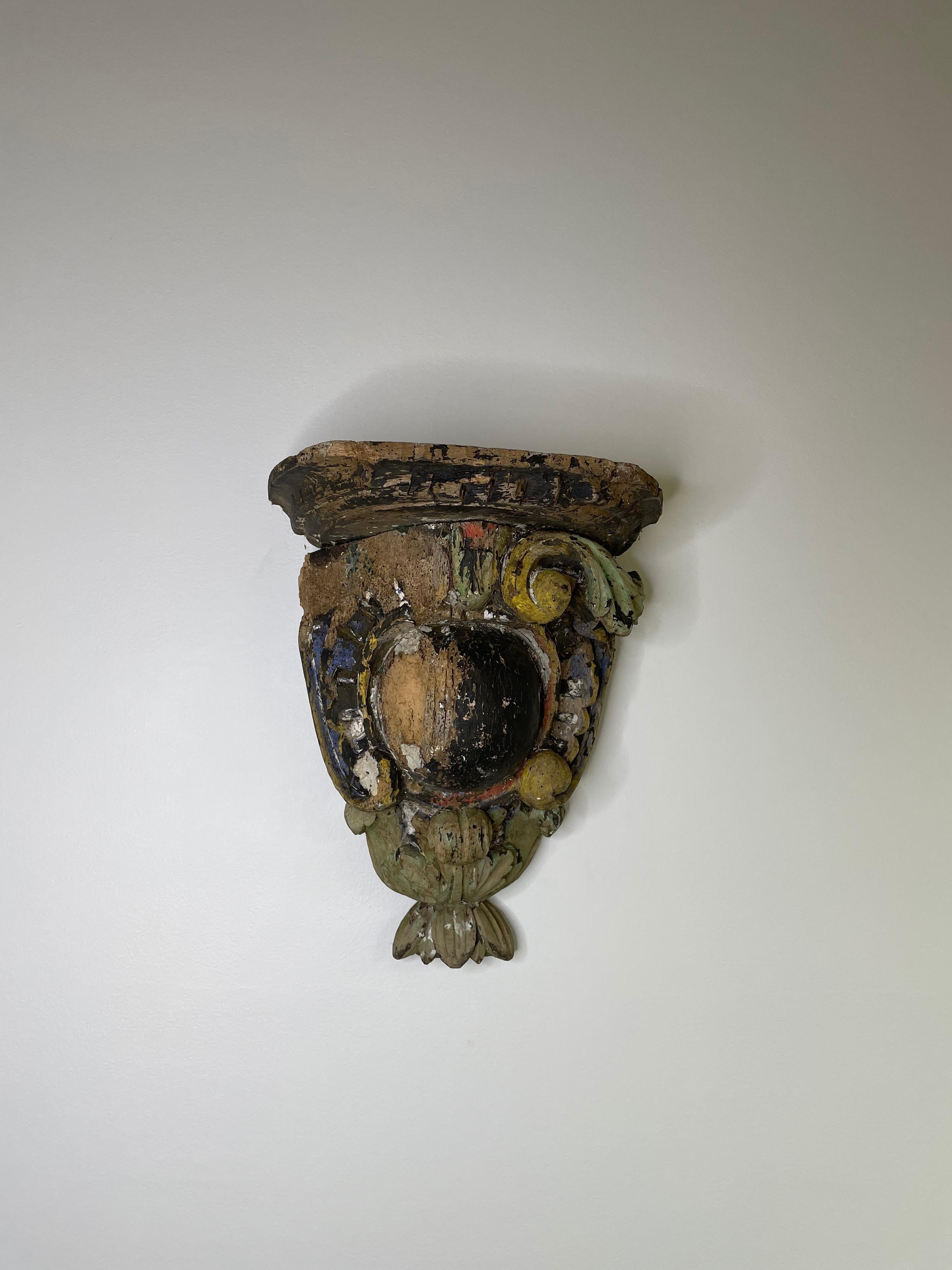 Antique multi-color oak bracket. Found in Northern France, with traces of polychrome on its face. It is a beautiful wall decoration as found, but could also serve as an interesting base for a small console.