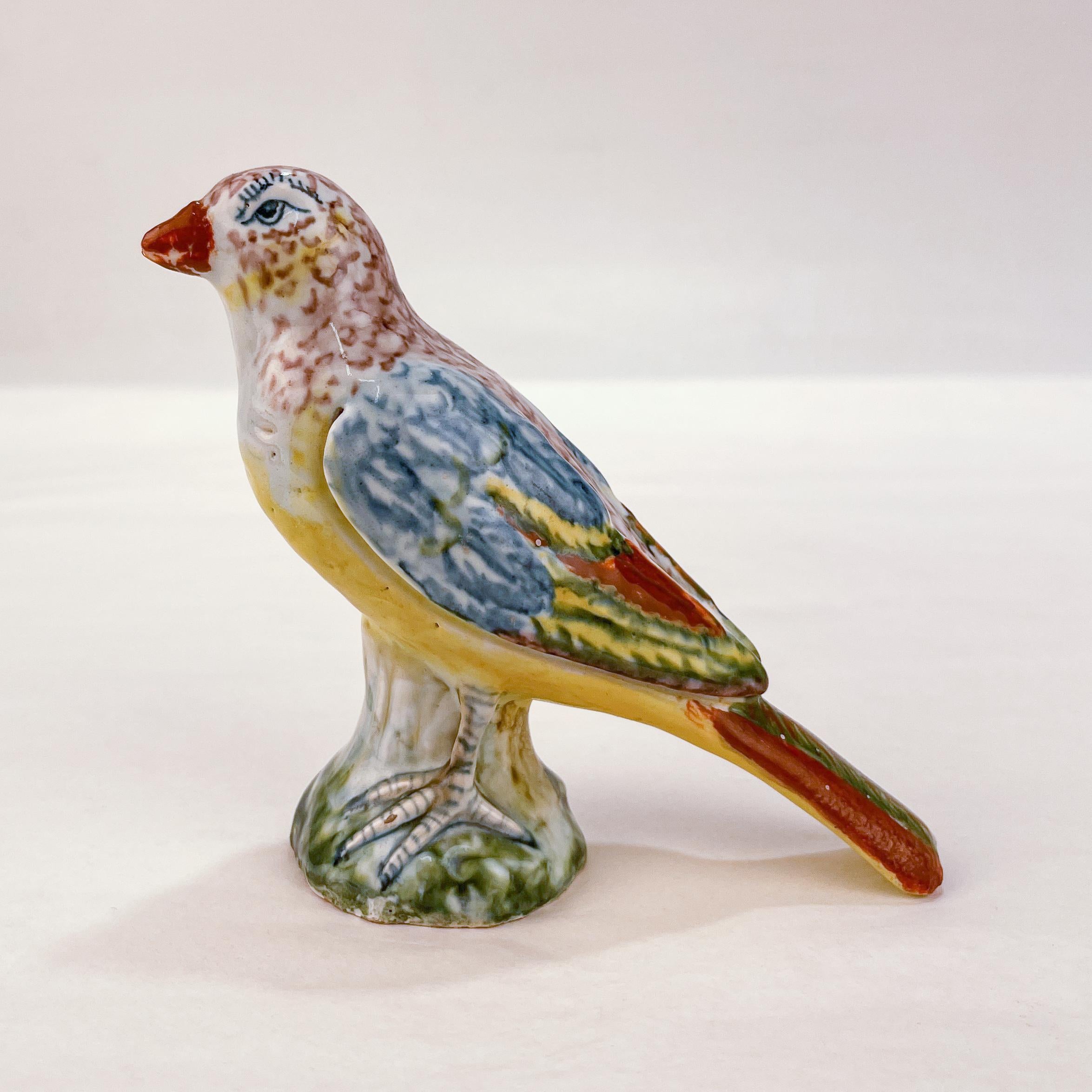A rare, antique Dutch Delft pottery figurine.

Modeled as a small bird on a figural tree stump plinth.

With a crimson painted AP maker's mark painted to the bottom. Possibly for Anthonij Pennis (1750-1770) or his widow Pennis-Overgaauw