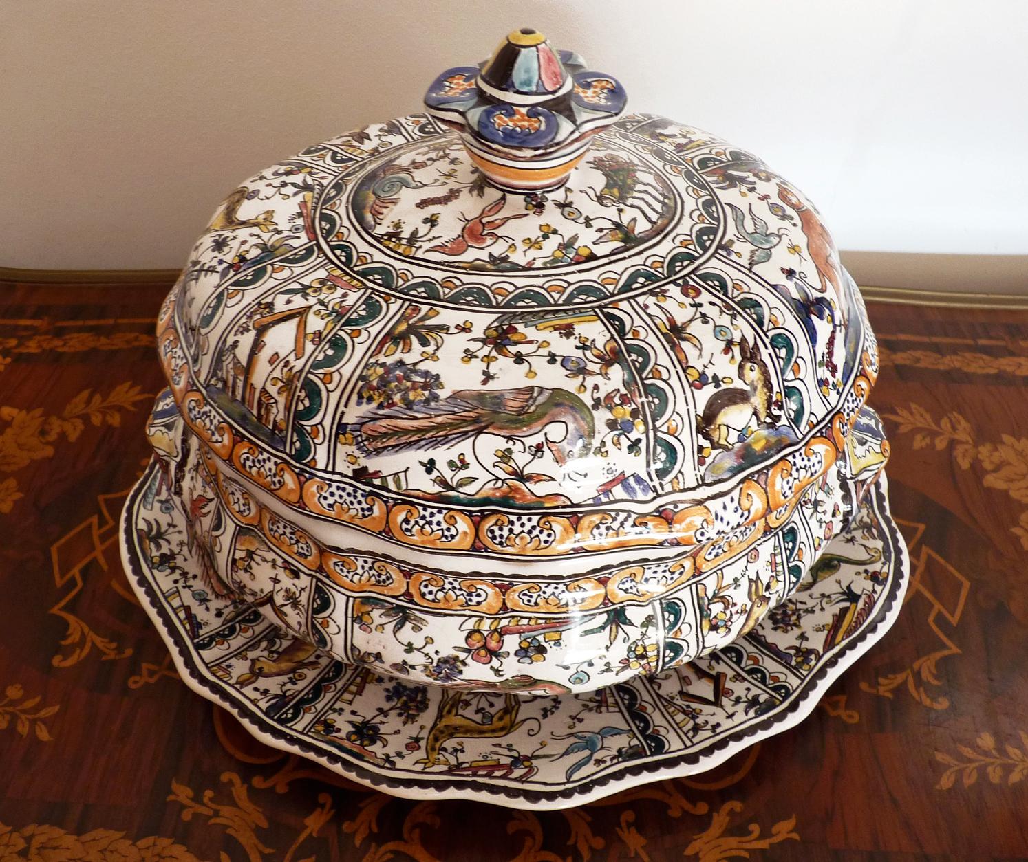 Delft polychrome Portuguese hand painted ceramic covered tureen with lid and under plate, hand painted 17th century, tin glazed faience with floral, hunting and bird motif, early 20th century, Numbered and signed.
The intricacy of the hand painted