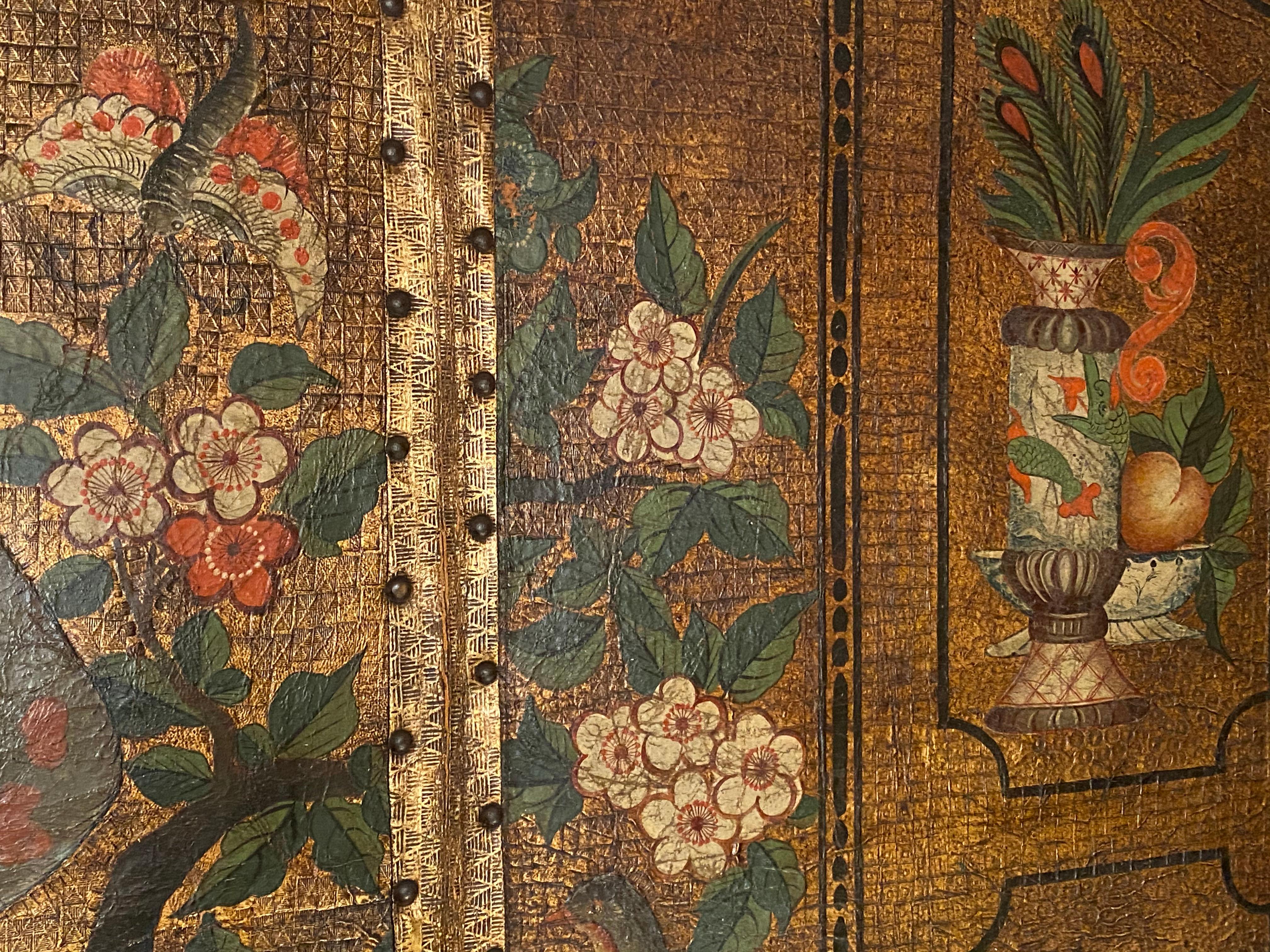 A polychrome-painted and gilt-decorated six-fold leather screen, or room divider, c 1800.

Superbly painted with exotic tropical birds perched on branches surrounded by gilt-foliate decorated borders, echoing the fashion for Chinoiserie so prevalent