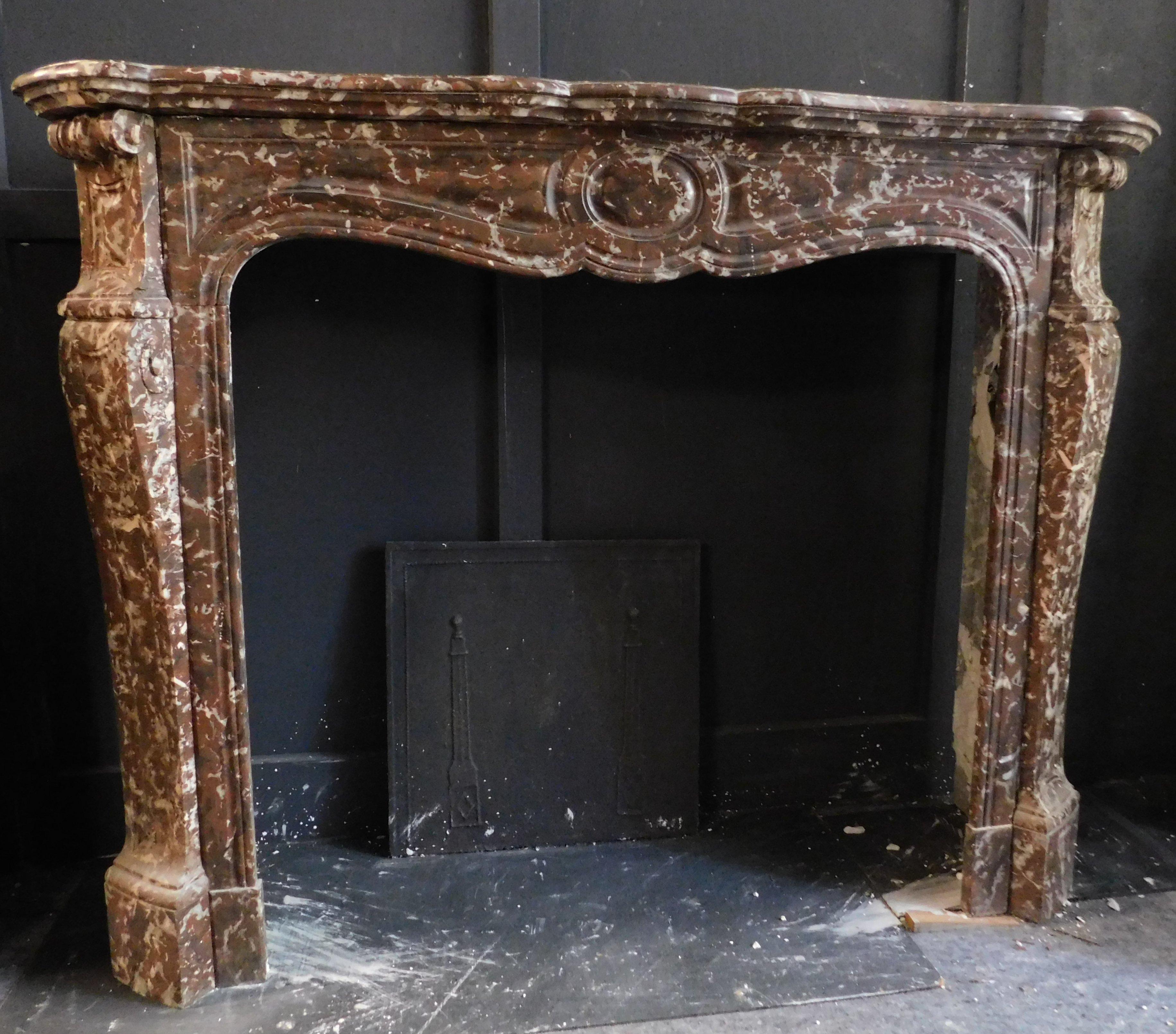 Ancient fireplace mantle, typical shape of the Pompadour model, hand-sculpted in French red marble, therefore obviously built in France in the 18th century.
Marble is very particular and beautiful, ideal for covering (even in a modern interior)