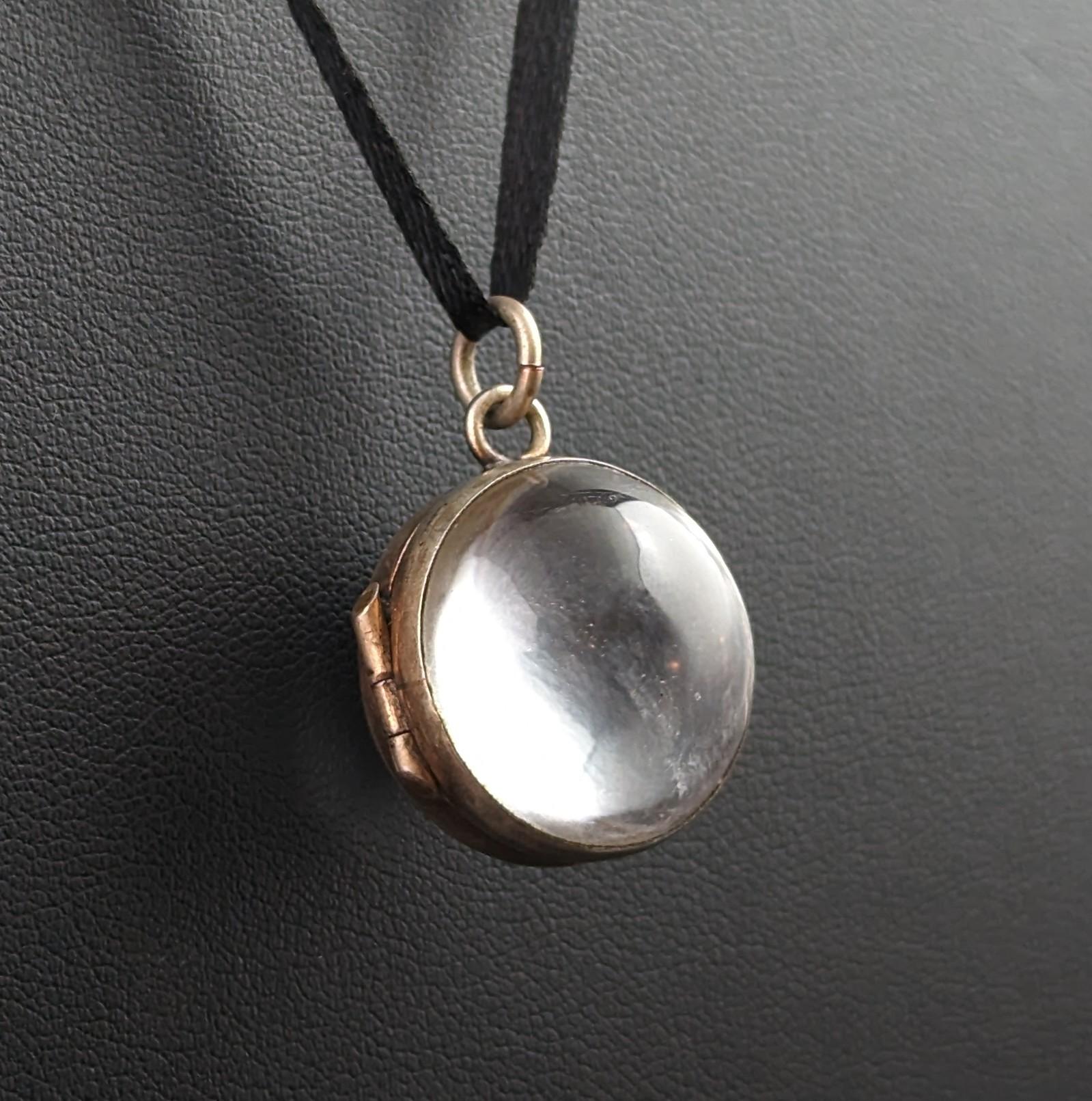 You cannot help but be mesmerised by this stunning antique, pools of light rock crystal locket pendant.

Beautiful high polished smooth rock crystal cabochons each set into a gilt silver frame, the spherical shape enhancing the enchanting glow from