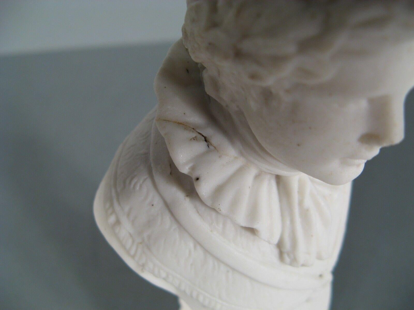 This captivating antique porcelain bust of Emperor Napoleon I, dating back to the late 19th or early 20th century, exudes a sense of historical grandeur and artistic craftsmanship, adding a touch of regality and Napoleonic charm to any collection.