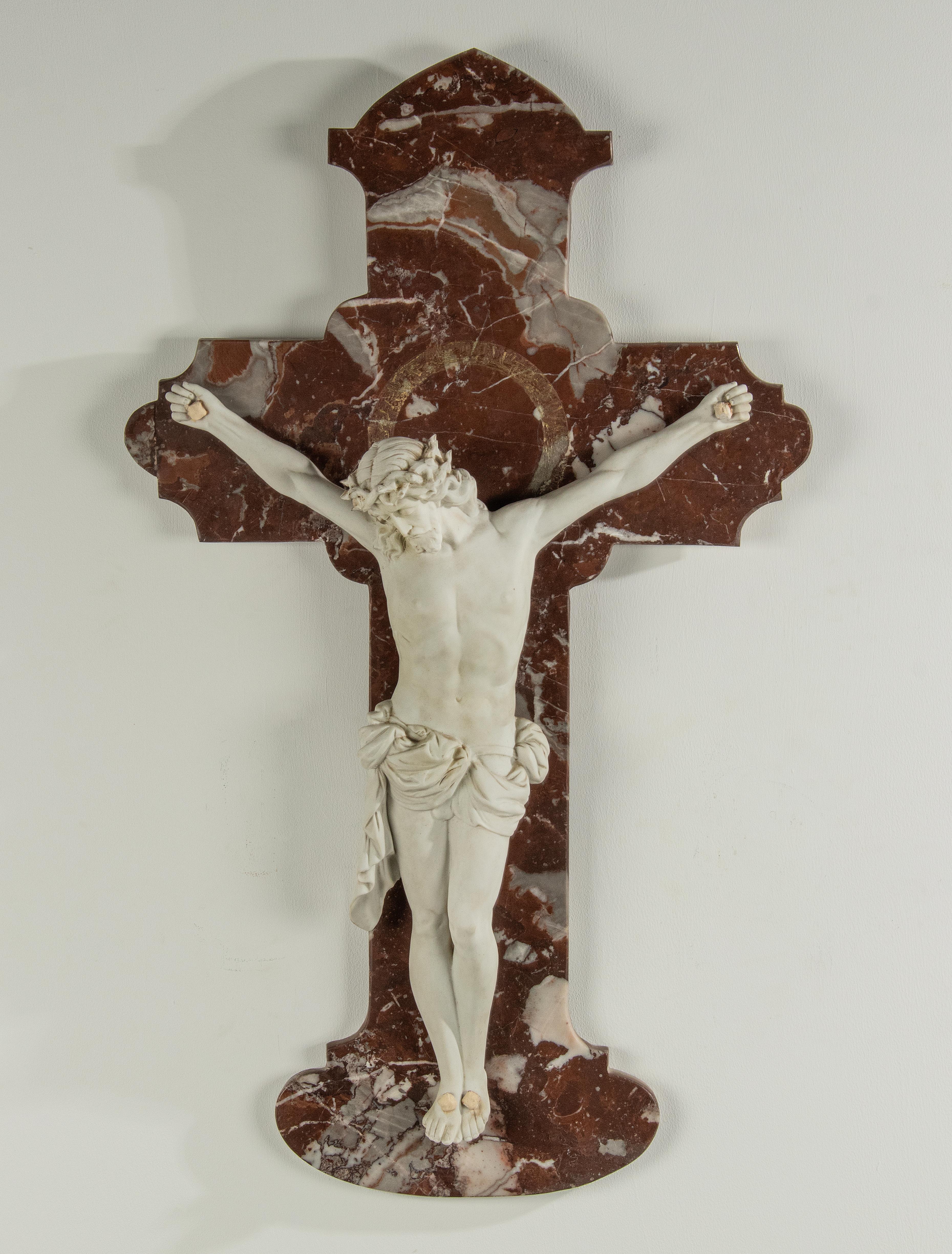 A large size, antique sculpture of Corpus Christi. The sculpture is made of unglazed porcelain, signed and numbered on the back: Sachsen. The porcelain figure of Jesus hangs on a red ‘Royal Rouge’ marble cross. This item is in good condition.