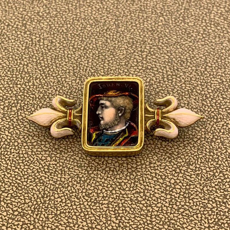 A one of a kind brooch and piece of history from the first half of the 19th century. It features a handmade porcelain portrait and soft enamel accents on the sides of the piece. Circa 1845 and made with 14k gold, this piece of art will add the