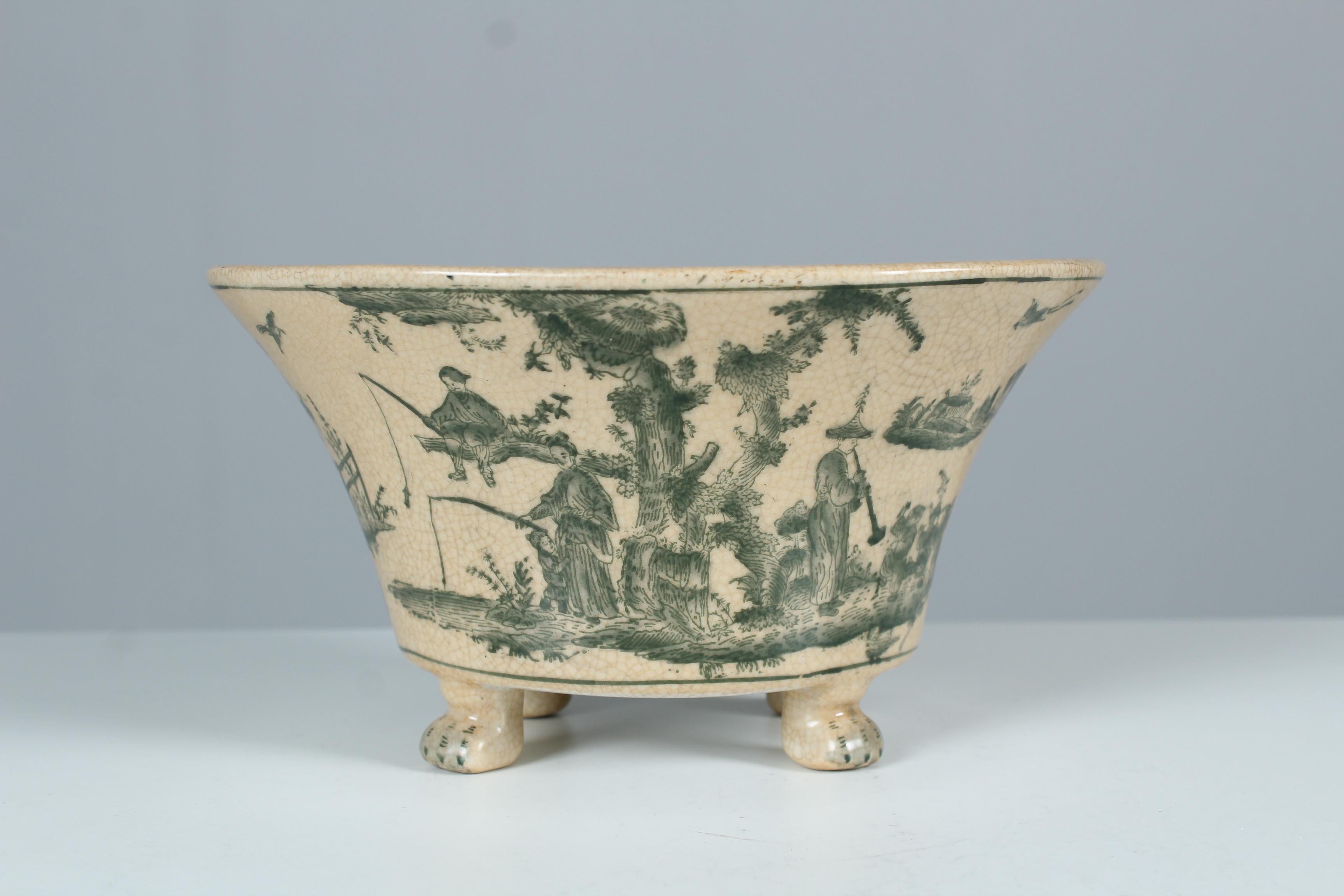 Antique jardiniere from G&C Interiors Denmark made of porcelain. Beautifully hand painted with various Chinese motifs, children playing and anglers in a setting with trees and a lake. For this purpose, a beautiful harmonious shade of green was used.