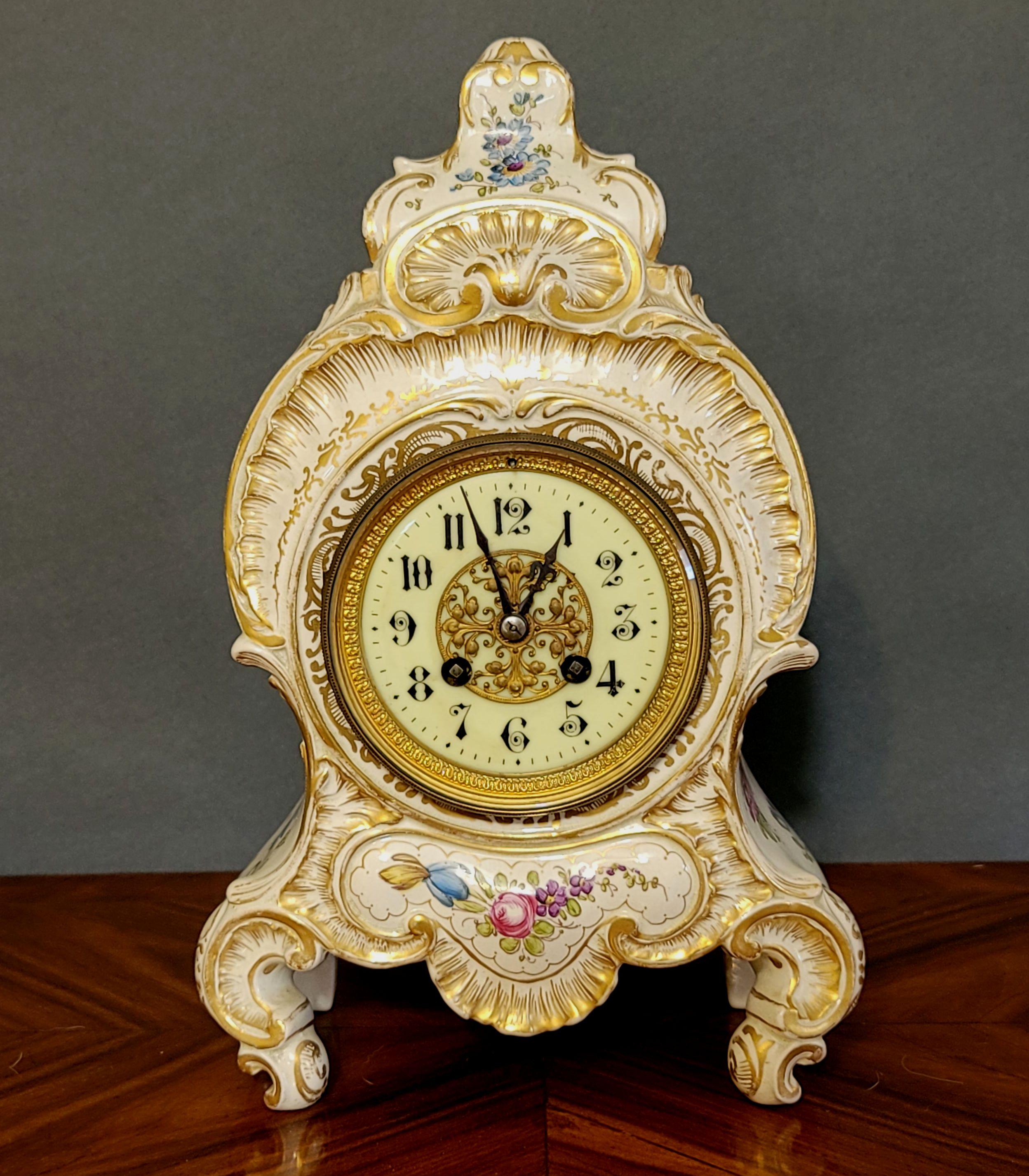 A hand-decorated with a floral motif for Bailey Banks and Biddle jewelers and gilt through the entire body. The painted porcelain dial on this clock is absolutely charming with hand-painted Arabic numerals in very delicate art writing, faux bois
