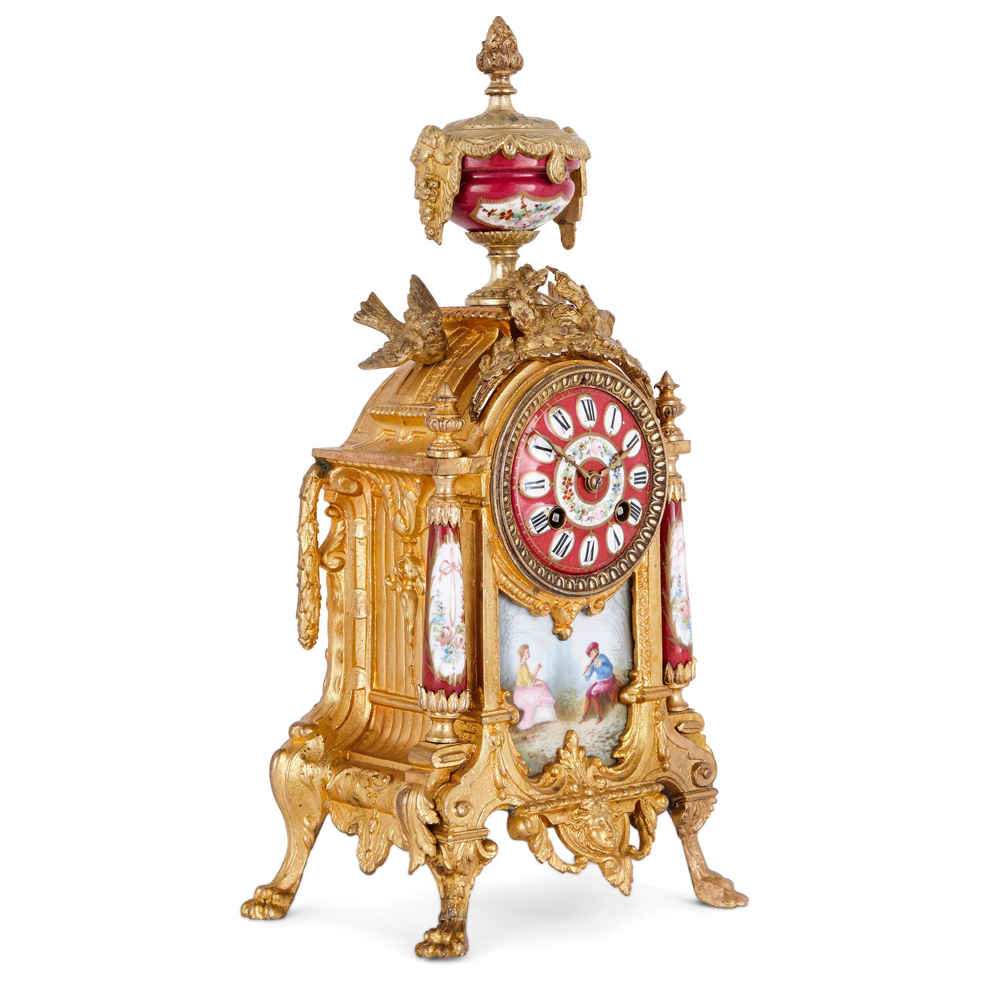 This wonderful clock set displays many of the characteristics of the 18th century Rococo style. These include gracefulness, asymmetry, and the use of curved forms. The set, which includes a mantel clock and pair of vases, is crafted from gilt metal