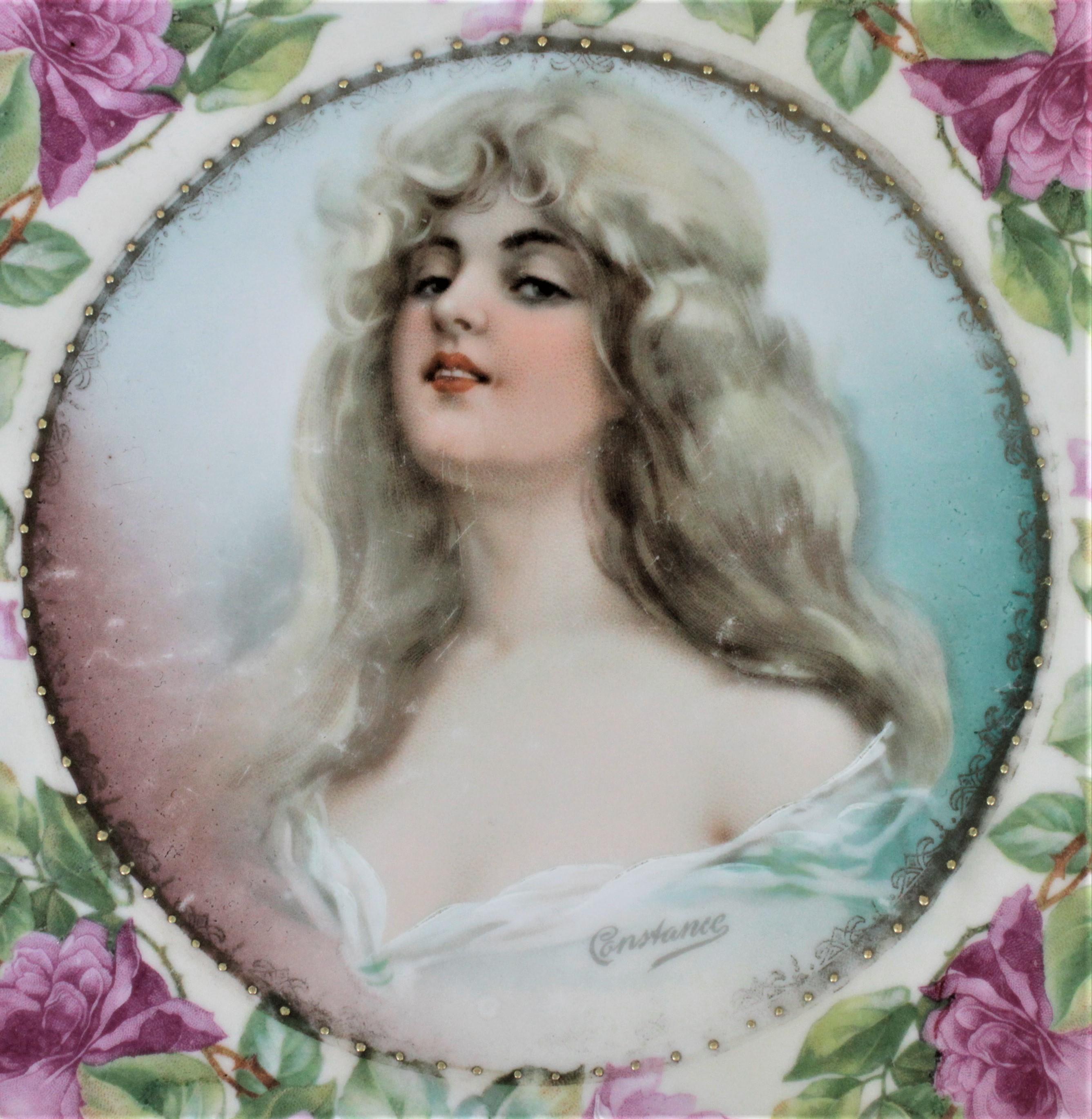 This antique portrait plate was made by the MZ Austria porcelain factory in circa 1908 in the late Victorian style. The plate features a young blonde female in a provocative pose for the time period, signed 