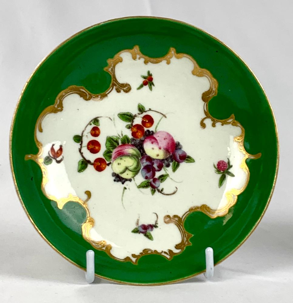 This First Period Worcester Porcelain trio set consists of a teacup, coffee cup, and saucer finely hand painted in the “Spotted Fruit” pattern circa 1770.
Painted by James Giles, the decoration features fruit and several flying insects within a