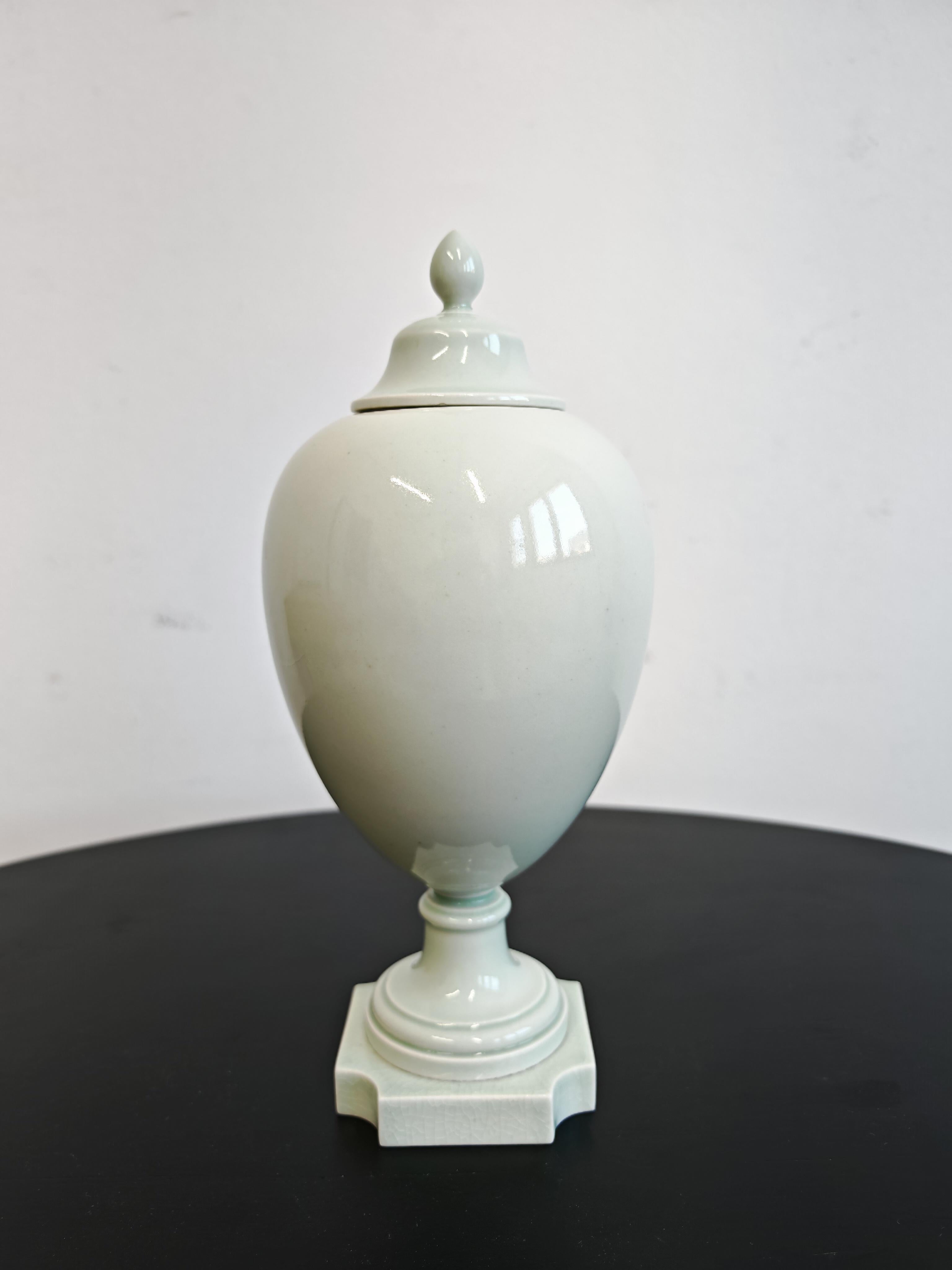In this listing you will find a celadon-colored porcelain urn or vase with a lid. It has a beautiful, pale green glaze, making it look very delicate and elegant. The vase has a Sevres hallmark on its bottom, as shown in pictures. It is estimated fo