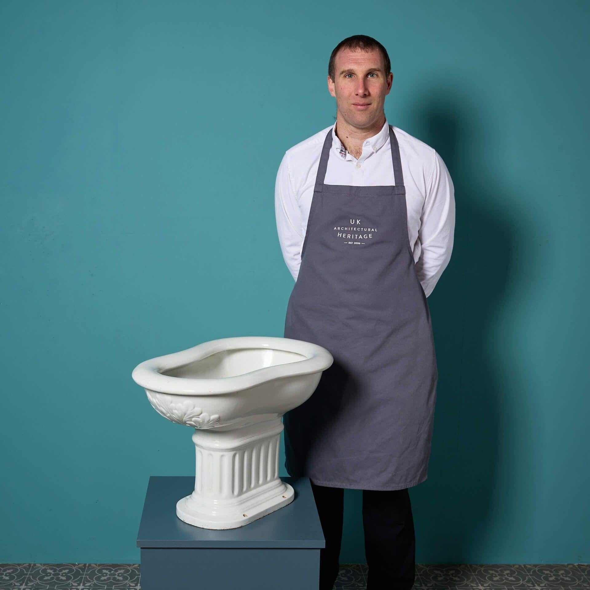 A beautifully shaped antique ceramic bidet by French manufacturers Porcher.

This early 20th century piece showcases a smooth curved shaped basin with a stunning stylised foliage pattern to its rim.

Sat on a fluted columned pedestal, finished by a