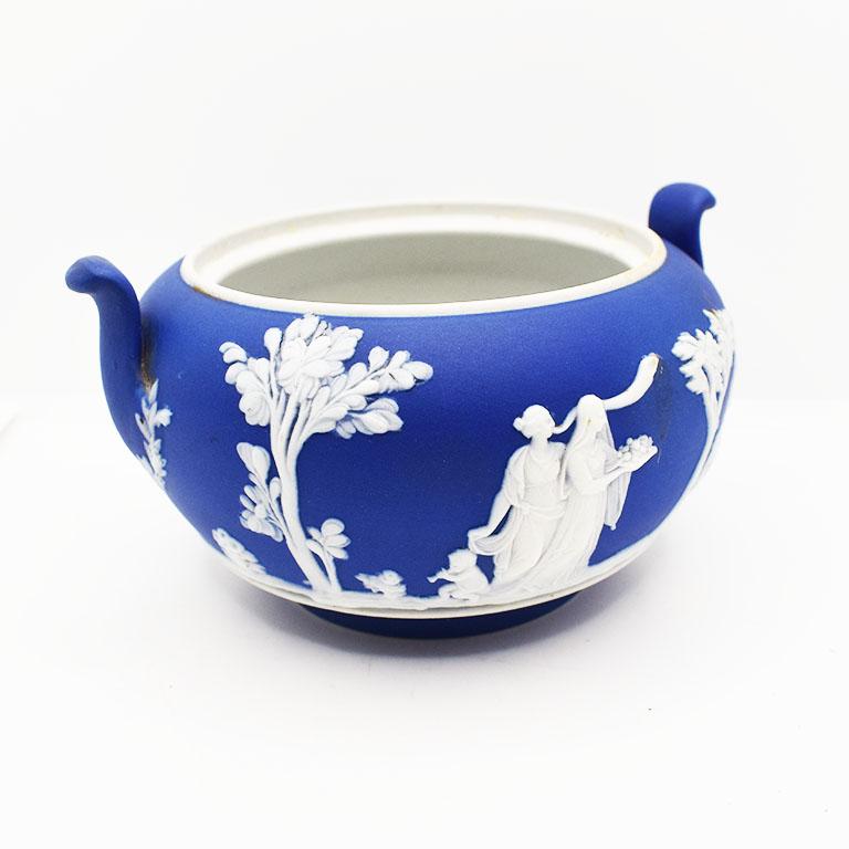 A stunning Neoclassical Wedgwood Portland blue bowl with a white overlay. This piece is believed to have been a small sugar bowl, however we think it would be fabulous used as a vase to hold a small bouquet of blooms.

Dimensions:
5