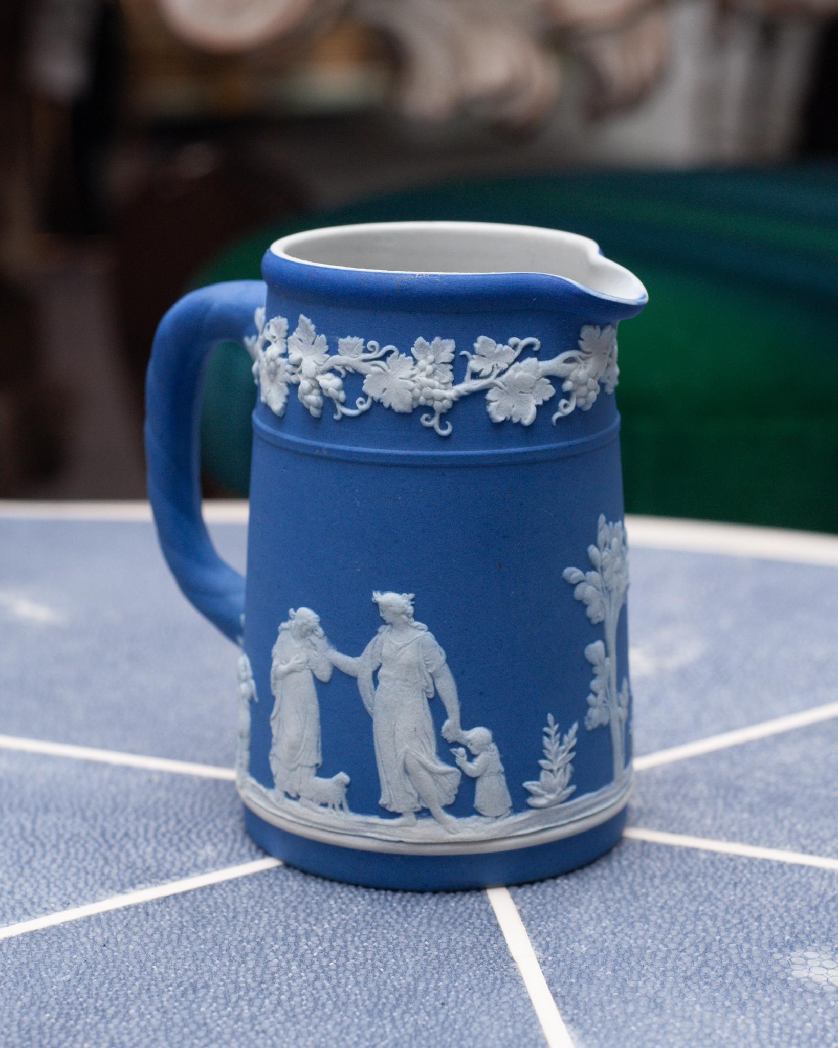 A stunning mid century Wedgwood Portland blue Jasperware small pitcher with white overlay, circa 1948.