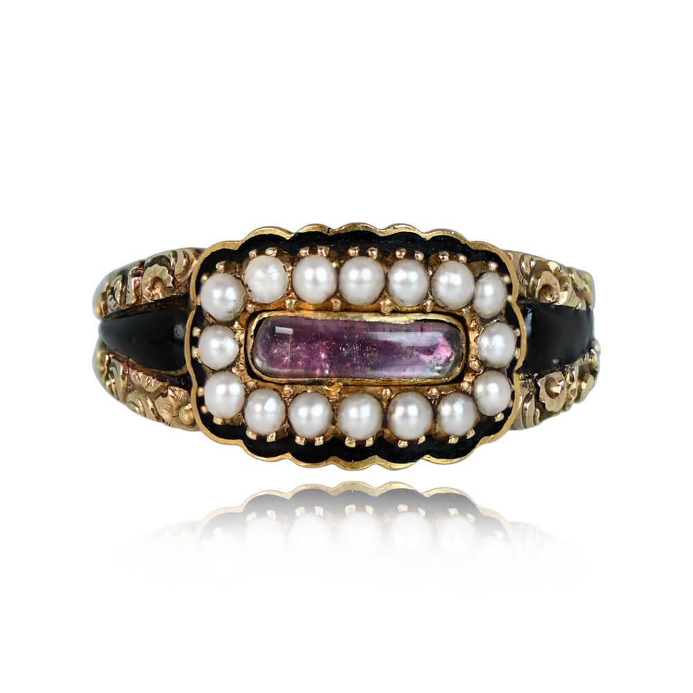 A captivating Georgian-era ring showcasing a bezel-set portrait-cut pink topaz backed with gold, encircled by a halo of prong-set seed pearls. Crafted in 18k yellow gold, the ring features black enamel detailing around the pearls and on the